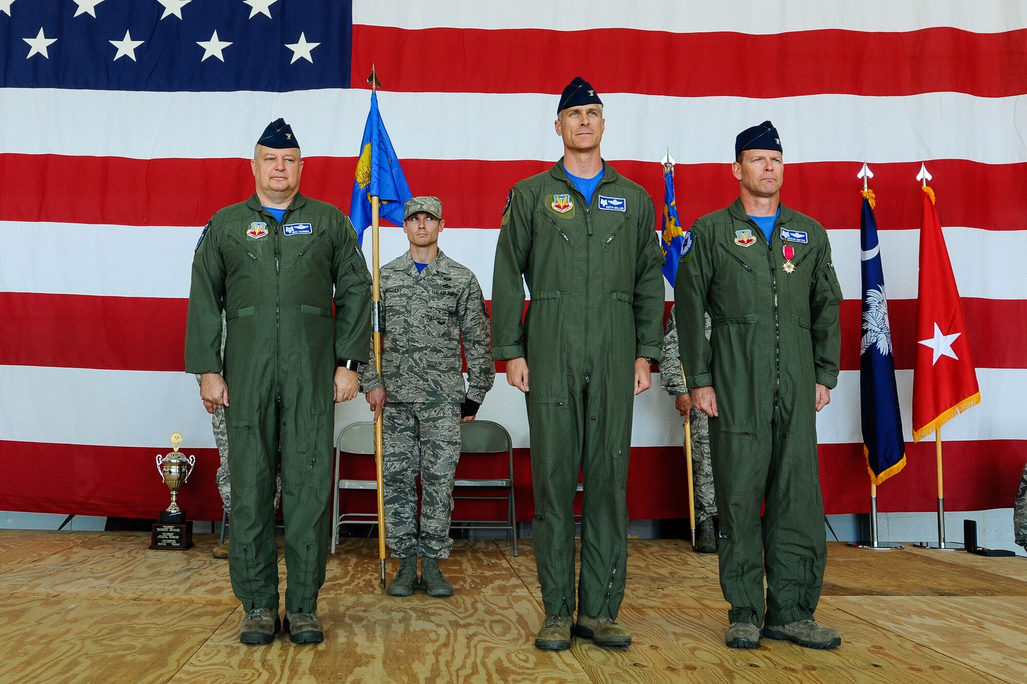 U.S. Airmen of the 169th Fighter Wing and the South Carolina Air National Guard, assemble for a change of command ceremony at McEntire Joint National Guard Base, S.C., May 3, 2014. Col. Michael Manning, left, presided over the exchange of the guidon as Col. Keith Miller, center, assumed command of the 169th Operations Group from Col. David Meyer, right. (U.S. Air National Guard photo by Tech. Sgt. Jorge Intriago/Released)