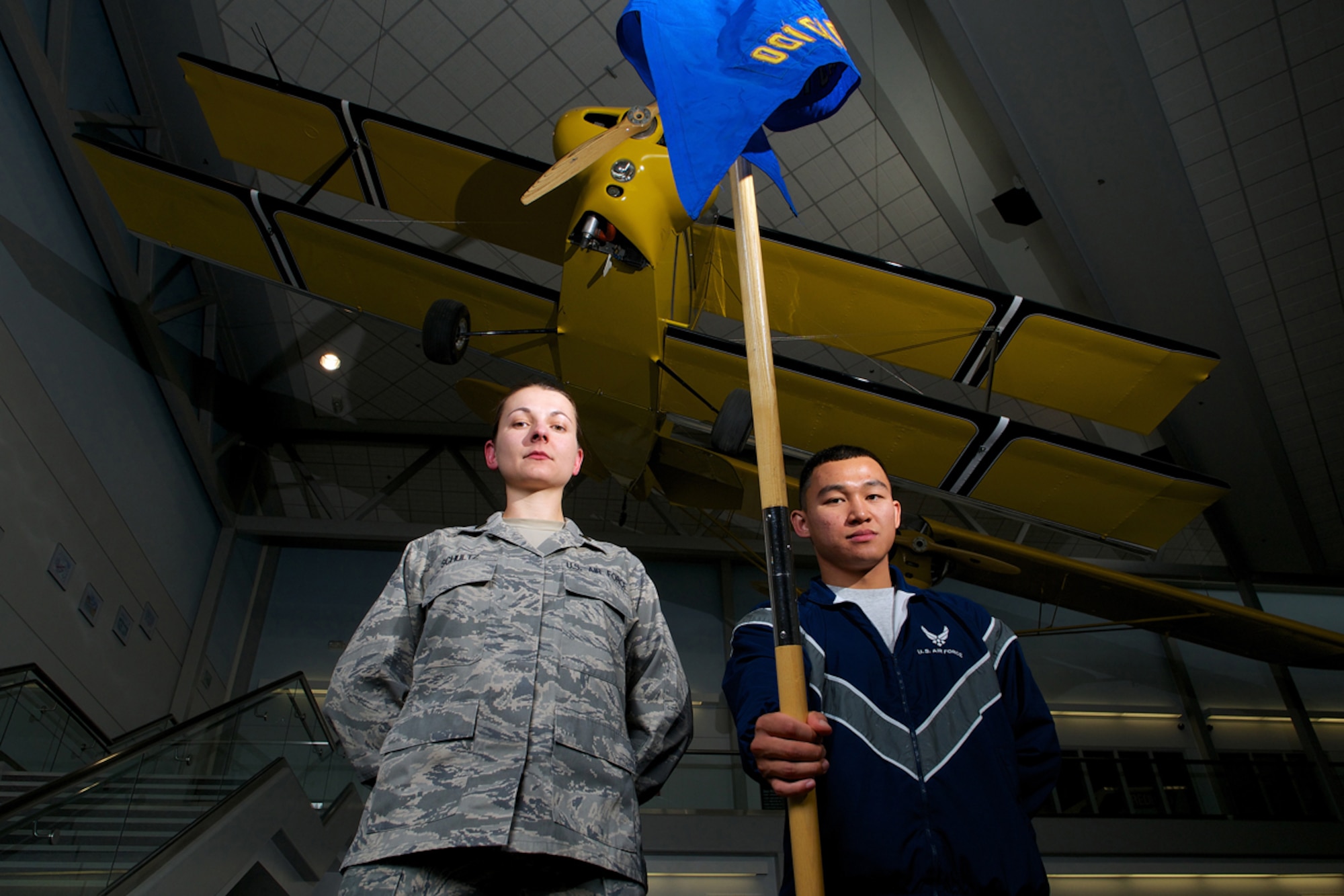 Then Cadet Emily Schultz and Cadet Jonathan Capua stand with the University of Alaska Anchorage Air Force ROTC guidon at the UAA Aviation Technology Building April 25. Schultz is from Fence, Wis., and recently commissioned as an Air Force second lieutenant in space and missile operations. Capua is from Patayak, Santa Barbara, Pagasanan, Philippines, and is concurrently a senior airman in the Air Force Reserve. He plans on commissioning in two years. (U.S. Air Force photo/David Bedard)