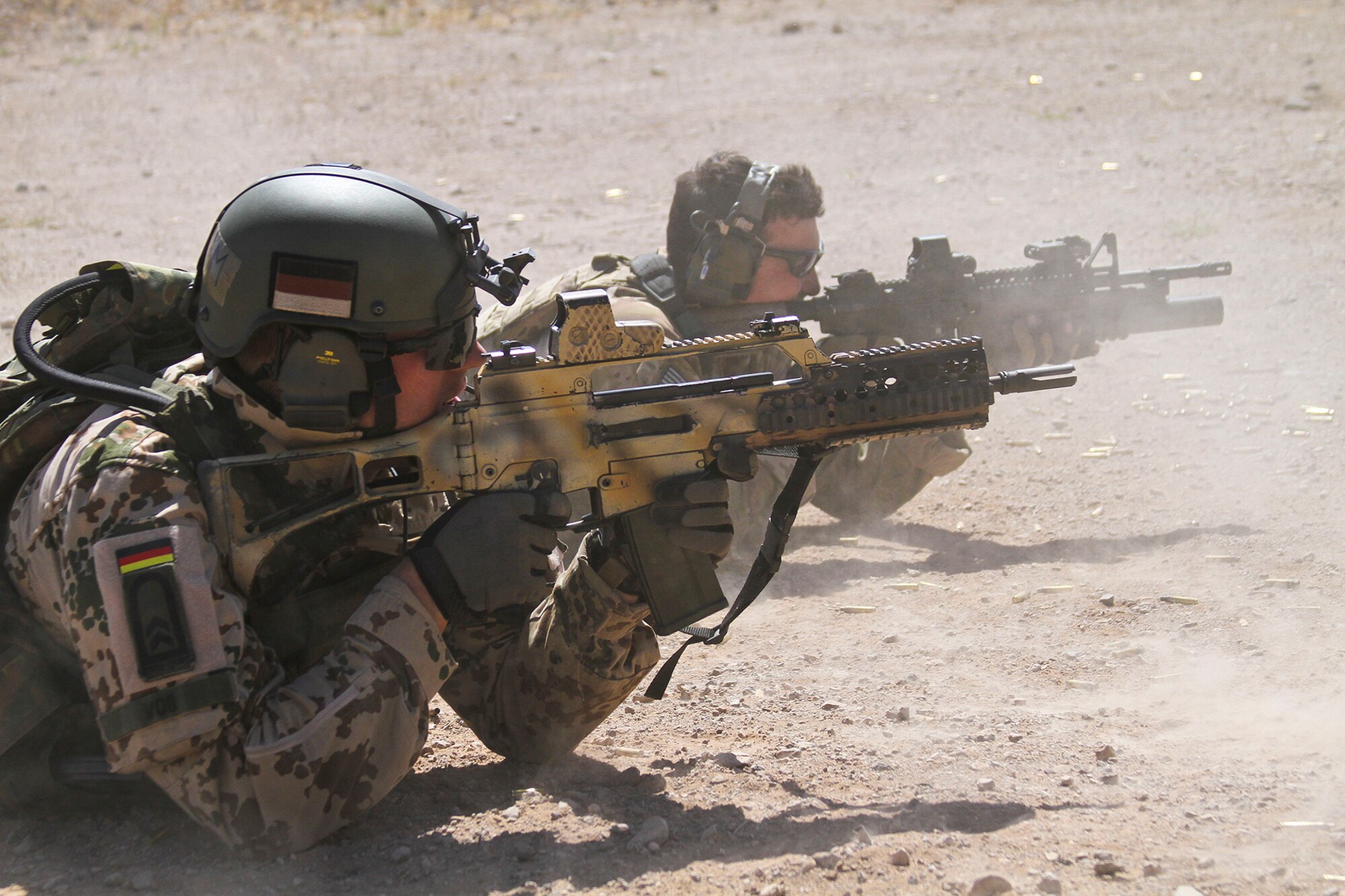 U.S. Airmen and German Air Force Rangers, train together on various shooting tactics during Exercise ANGEL THUNDER at Three Points Firing Range in Tucson, Ariz., May 12, 2014.  ANGEL THUNDER is the only exercise in the Department of Defense covering personnel recovery training across the full spectrum of irregular and conventional warfare and has become the world’s largest and most complex personnel recovery exercise. Through the use of joint training, members are able to hone their development of the four core functions of personnel recovery which include preparing, planning, execution, and adaptation. ANGEL THUNDER is designed to provide state of the art rescue training for the total Air Force rescue community, as well as Joint U.S. Military, federal government agencies, local communities, non-governmental agencies and allied nations.  (U.S. Air Force photo by Tech. Sgt. Heather R. Redman/Released)