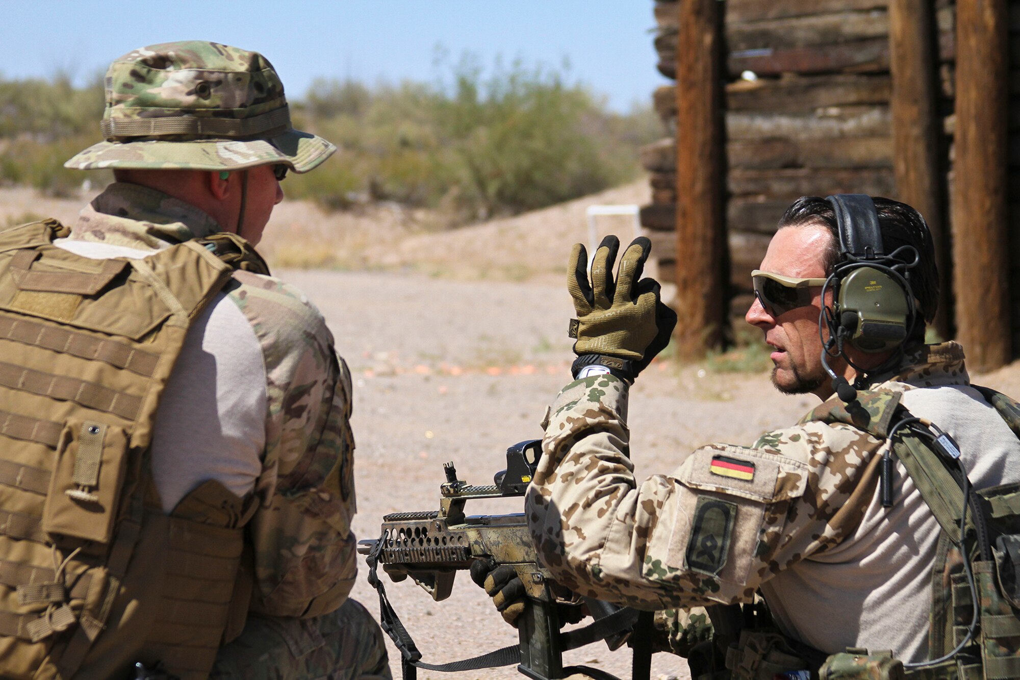 U.S. Airmen and German Air Force Rangers, train together on various shooting tactics during Exercise ANGEL THUNDER at Three Points Firing Range in Tucson, Ariz., May 12, 2014.  ANGEL THUNDER is the only exercise in the Department of Defense covering personnel recovery training across the full spectrum of irregular and conventional warfare and has become the world’s largest and most complex personnel recovery exercise. Through the use of joint training, members are able to hone their development of the four core functions of personnel recovery which include preparing, planning, execution, and adaptation. ANGEL THUNDER is designed to provide state of the art rescue training for the total Air Force rescue community, as well as Joint U.S. Military, federal government agencies, local communities, non-governmental agencies and allied nations.  (U.S. Air Force photo by Tech. Sgt. Heather R. Redman/Released)