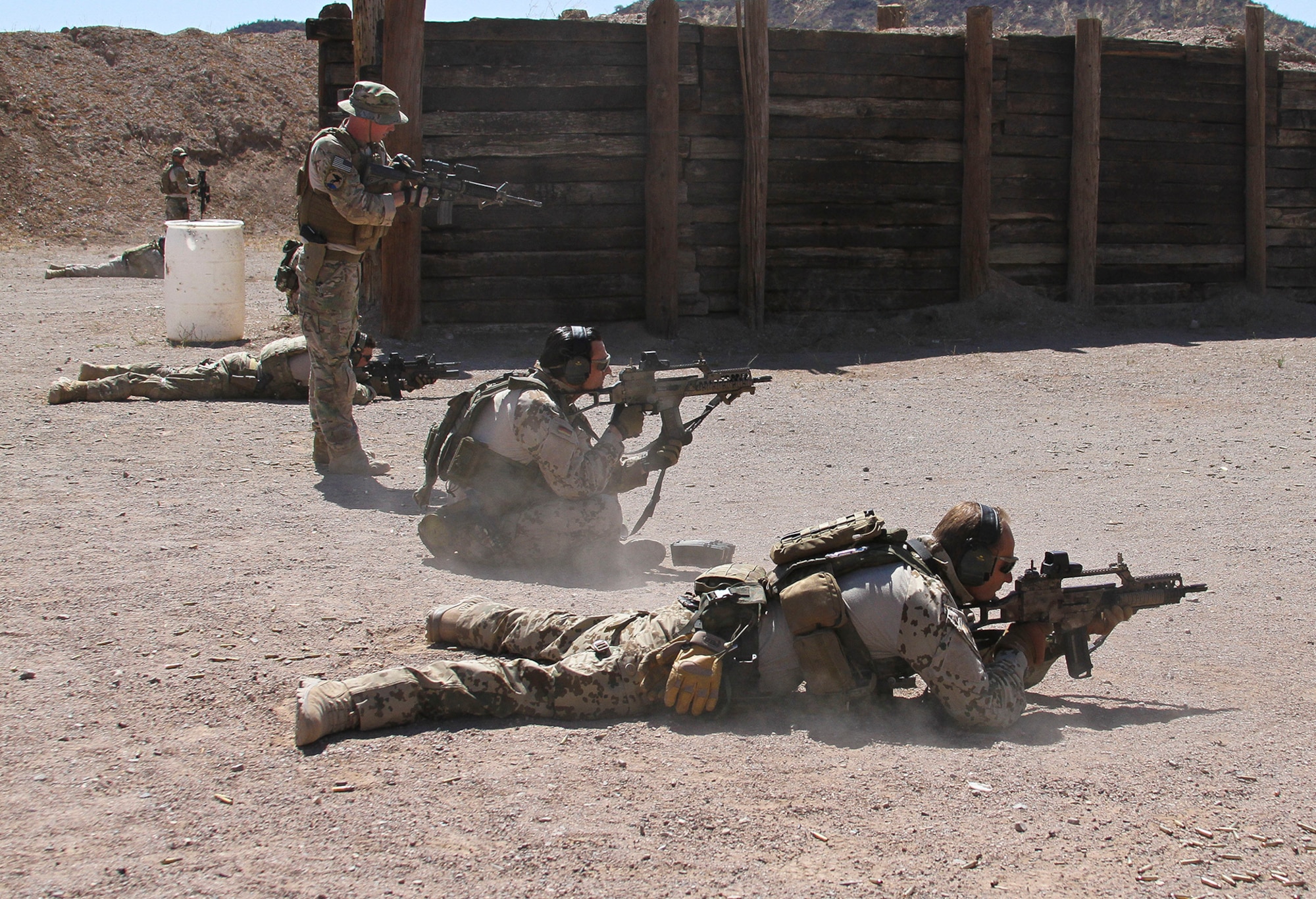 U.S. Airmen and Marines, along with German and Swedish Air Force Rangers, train together on various shooting tactics during Exercise ANGEL THUNDER at Three Points Firing Range in Tucson, Ariz., May 12, 2014.  ANGEL THUNDER is the only exercise in the Department of Defense covering personnel recovery training across the full spectrum of irregular and conventional warfare and has become the world’s largest and most complex personnel recovery exercise. Through the use of joint training, members are able to hone their development of the four core functions of personnel recovery which include preparing, planning, execution, and adaptation. ANGEL THUNDER is designed to provide state of the art rescue training for the total Air Force rescue community, as well as Joint U.S. Military, federal government agencies, local communities, non-governmental agencies and allied nations.  (U.S. Air Force photo by Tech. Sgt. Heather R. Redman/Released)