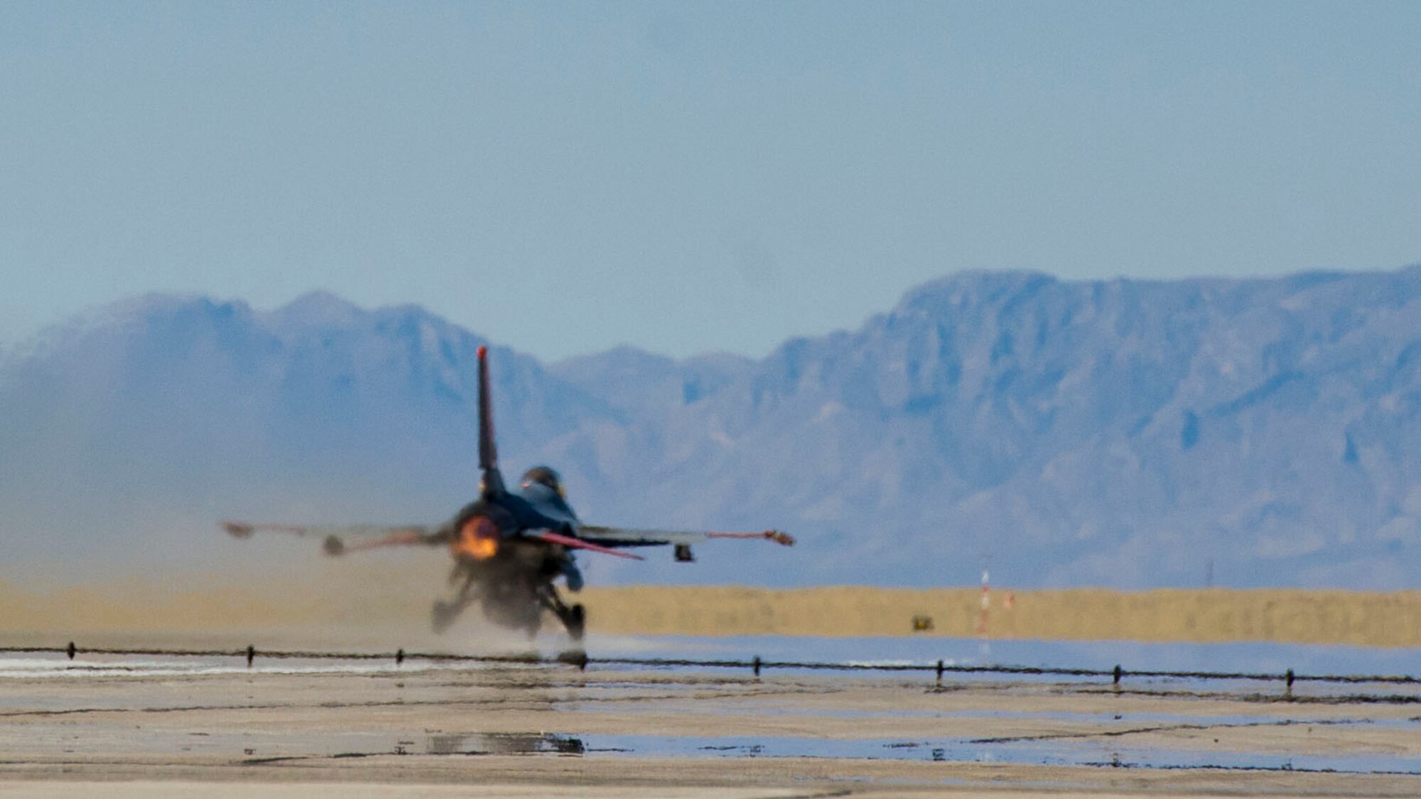 An unmanned QF-16 aircraft launches for a graduation exercise at Holloman Air Force Base, N.M., May 14.  The graduation exercise tests the aircraft’s capabilities and connectivity to the White Sands Test System at White Sands Missile Range.  The unmanned QF-16’s were converted to remotely piloted aircraft from retired F-16 Fighting Falcons.  This is the second unmanned QF-16 to launch in history and the first to launch at Holloman AFB.  (U.S. Air Force photo by Staff Sgt. E’Lysia Wray/Released)