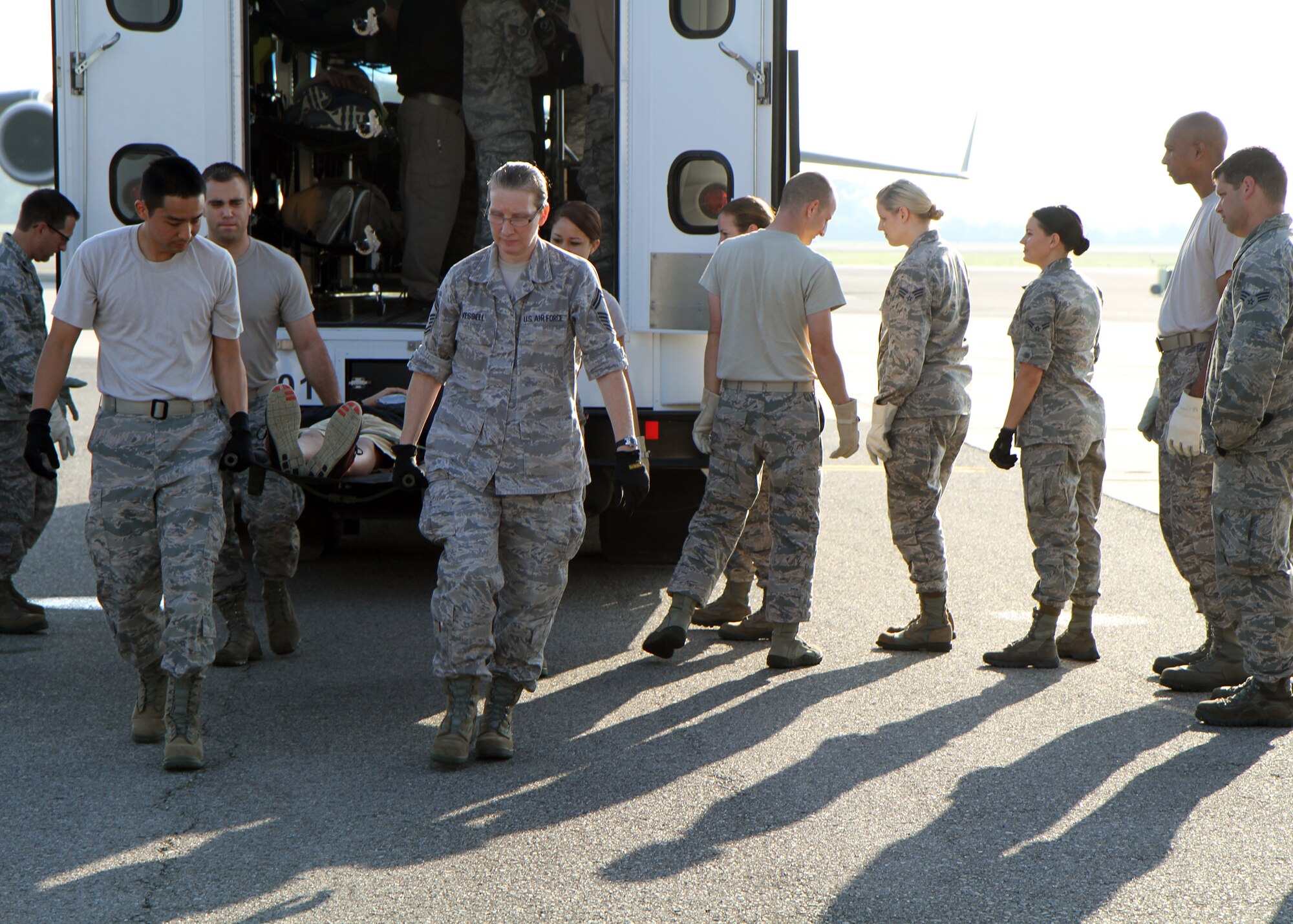 Reserve and active duty Airmen serving at Joint Base Charleston, S.C., transfer a simulated litter patient from a specialized Dual Use Vehicle provided by the VA to the cargo area of a C-17 Globemaster III during a multi-agency patient evacuation exercise held at Joint Base Charleston and in Greenville, S.C., May 14, 2014. The exercise was organized through the National Disaster Medical System, which coordinates several federal, state and local emergency response agencies in times of crisis and mass casualty. (U.S. Air Force photo by Senior Airman Meredith A. H. Thomas)