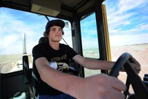 Dakota Case, Ellicott High School student, operates a vehicle during the Job Shadow Day May 9, 2014, at Schriever Air Force Base, Colo. Case was paired up with the 50th Civil Engineer Squadron where he learned about building a foundation. (U.S. Air Force photo/Dennis Rogers)  