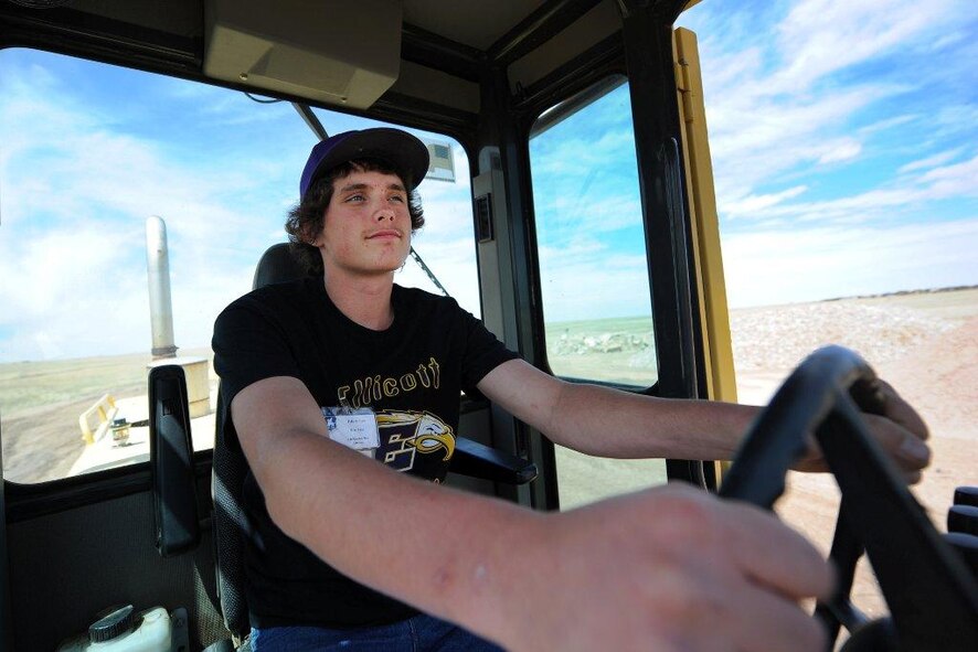 Dakota Case, Ellicott High School student, operates a vehicle during the Job Shadow Day May 9, 2014, at Schriever Air Force Base, Colo. Case was paired up with the 50th Civil Engineer Squadron where he learned about building a foundation. (U.S. Air Force photo/Dennis Rogers)  