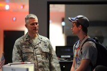 Lt. Col. Matthew Brandt, 2nd Space Operations Squadron director of operations, talks to Matt Finch, Ellicott High School student, about the GPS mission May 9, 2014, at Schriever Air Force Base, Colo. Brandt showed the students what Airmen in his unit do on a daily basis. (U.S. Air Force photo/Dennis Rogers)