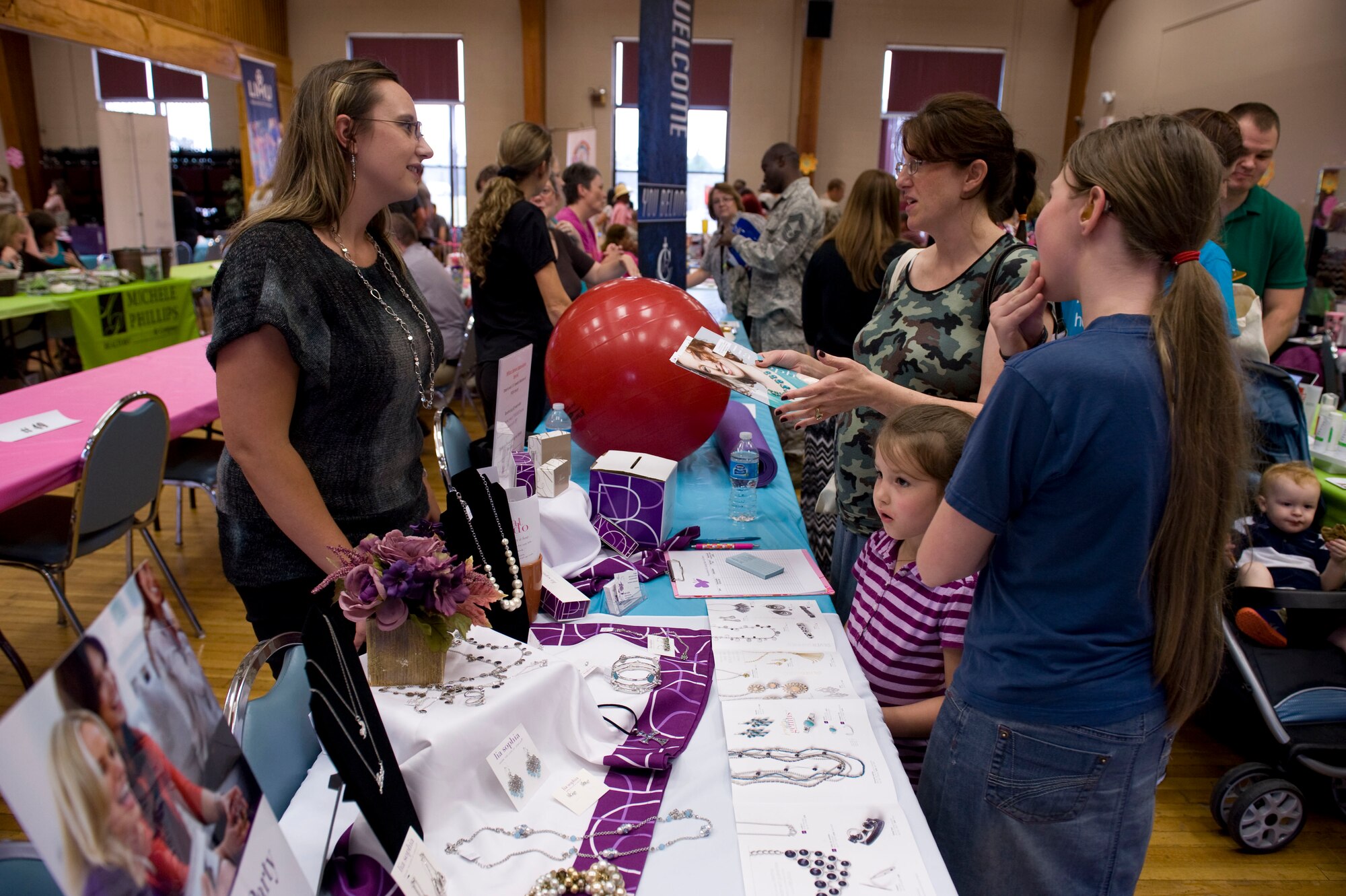 Spouses shop during the Spouse Appreciation Day Bazaar at the Thomas Community Activities Center May 9, 2014, at Little Rock Air Force Base, Ark. Spouses and their families from all branches of service, whether active duty or retired, were welcomed to enjoy the festivities of the events. (U.S. Air Force photo by Airman 1st Class Cliffton Dolezal)