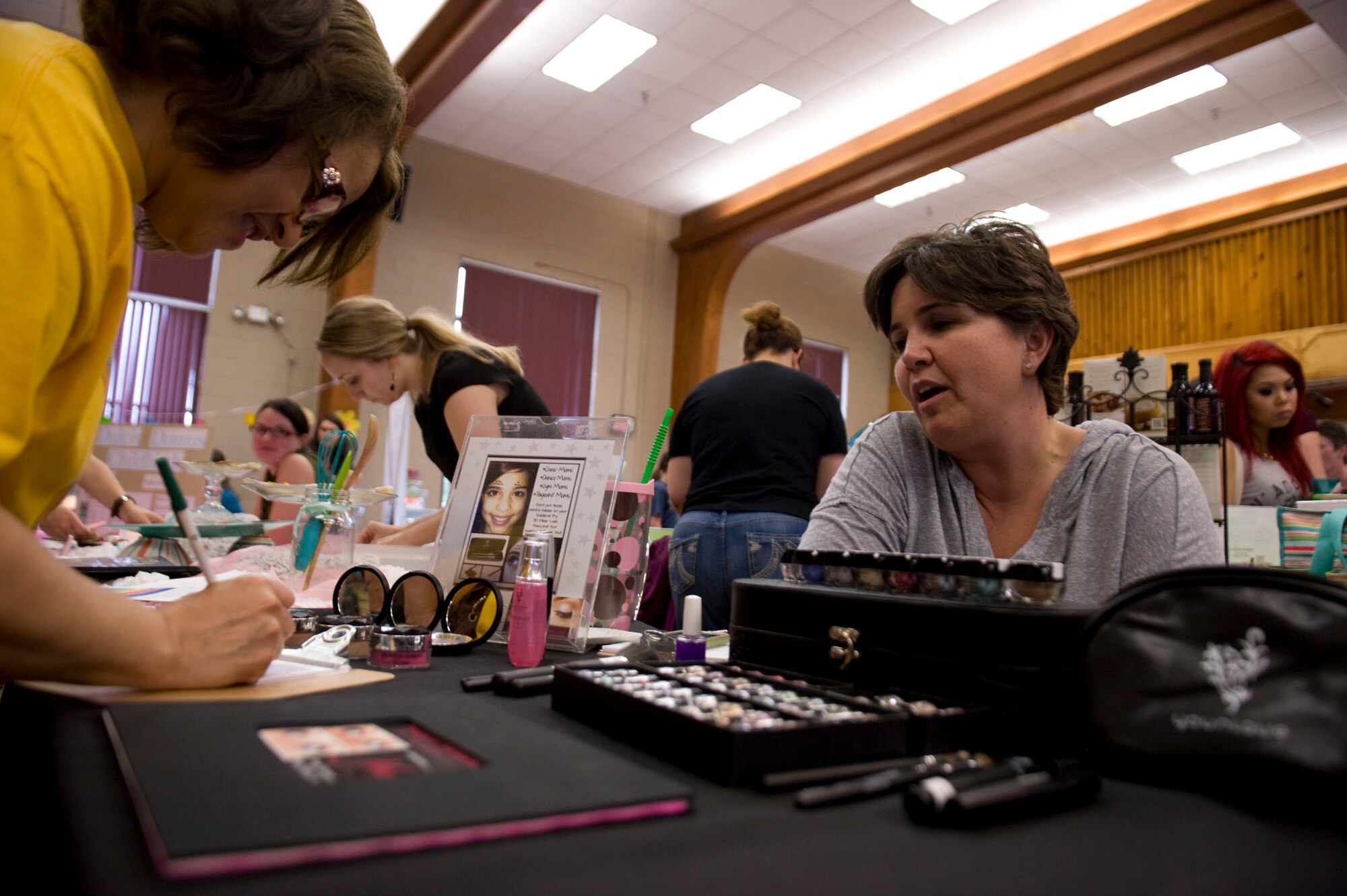 A vendor from the Spouse Appreciation Day Bazaar speaks with a participant May 9, 2014, at Little Rock Air Force Base, Ark. Spouse Appreciation Day was sponsored by the Airman and Family Readiness Center and included a free tour of Jacksonville, a free spa night and a bazaar. (U.S. Air Force photo by Airman 1st Class Cliffton Dolezal)