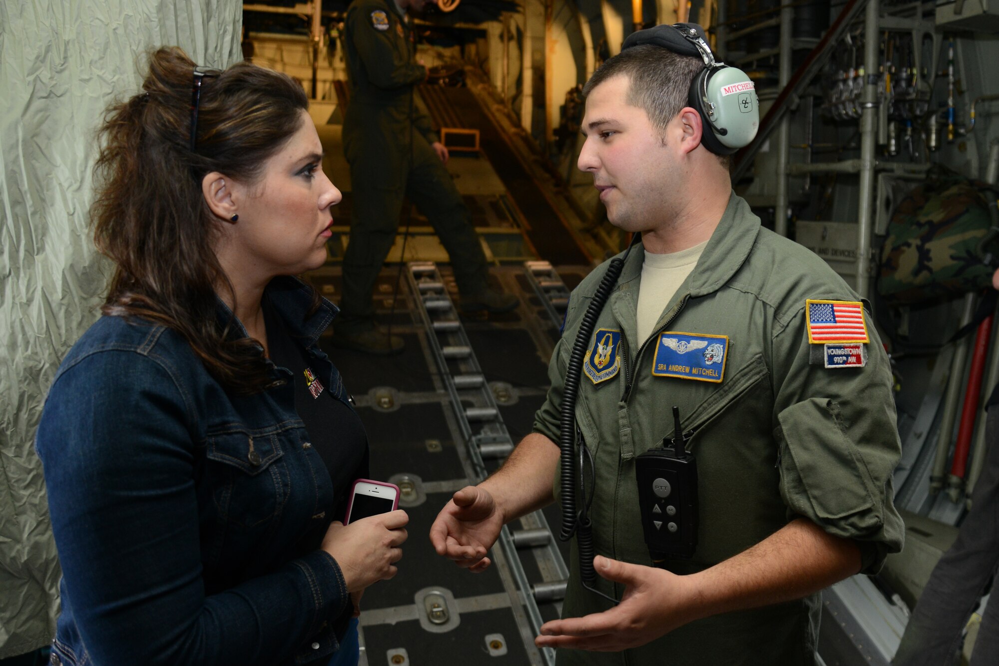 Senior Airman Andrew Mitchell, a Loadmaster for 757th Airlift Squadron, is interviewed by Jennifer Brindisi during a C-130 Media Flight here, May 14, 2014. The Media flight left from Youngstown Air Reserve Station to fly at an altitude of 3000 feet over the cities of Cleveland, Akron and Youngstown.  Brenda is a television Broadcaster for local affiliate WFMJ, Youngstown and was among several other local media representatives in attendance on the flight. U.S. Air Force photo/Tech. Sgt. Jim Brock.