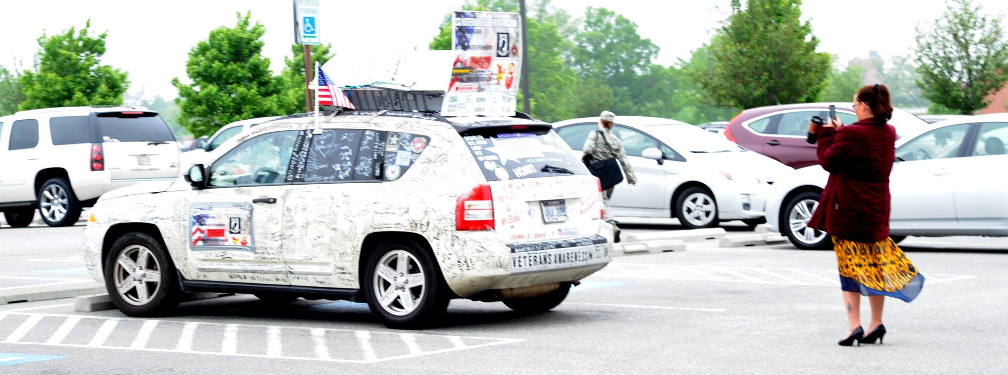 Shannonlee Stout takes a photo of a car covered in signatures of American, Canadian and Mexican military veterans along with civilian messages of support at Joint Base Andrews, Md., May 14, 2014. The car belongs to Lisa Groves who served in the U.S. Army and is now a veteran advocate. She is on her second nationwide journey promoting awareness of veterans’ struggles, which she began June 2, 2013. Stout is an Air Force District of Washington budget analyst. (U.S. Air Force photo/Master Sgt. Tammie Moore)