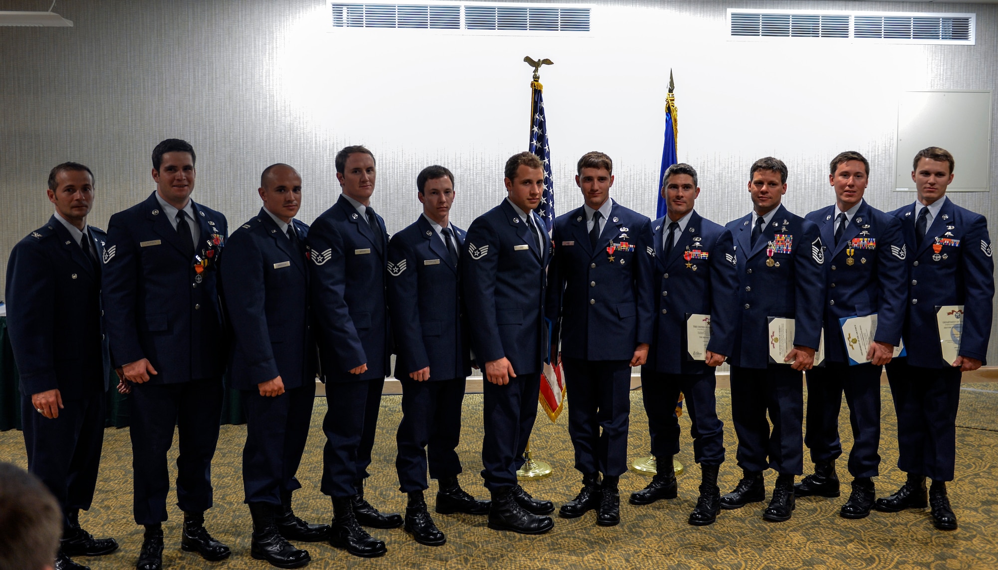 Col. Thad Allen, 22nd Special Tactics Squadron commander, presents Airmen from the 22nd STS silver team, May 14, 2014, during the 22nd STS awards ceremony and dining-out at Joint Base Lewis-McChord, Wash. Members of this team were awarded 15 Air Force medals to include a Bronze Star Medal with Valor, and eight Bronze Star Medals. (U.S. Air Force photo/Staff Sgt. Russ Jackson)