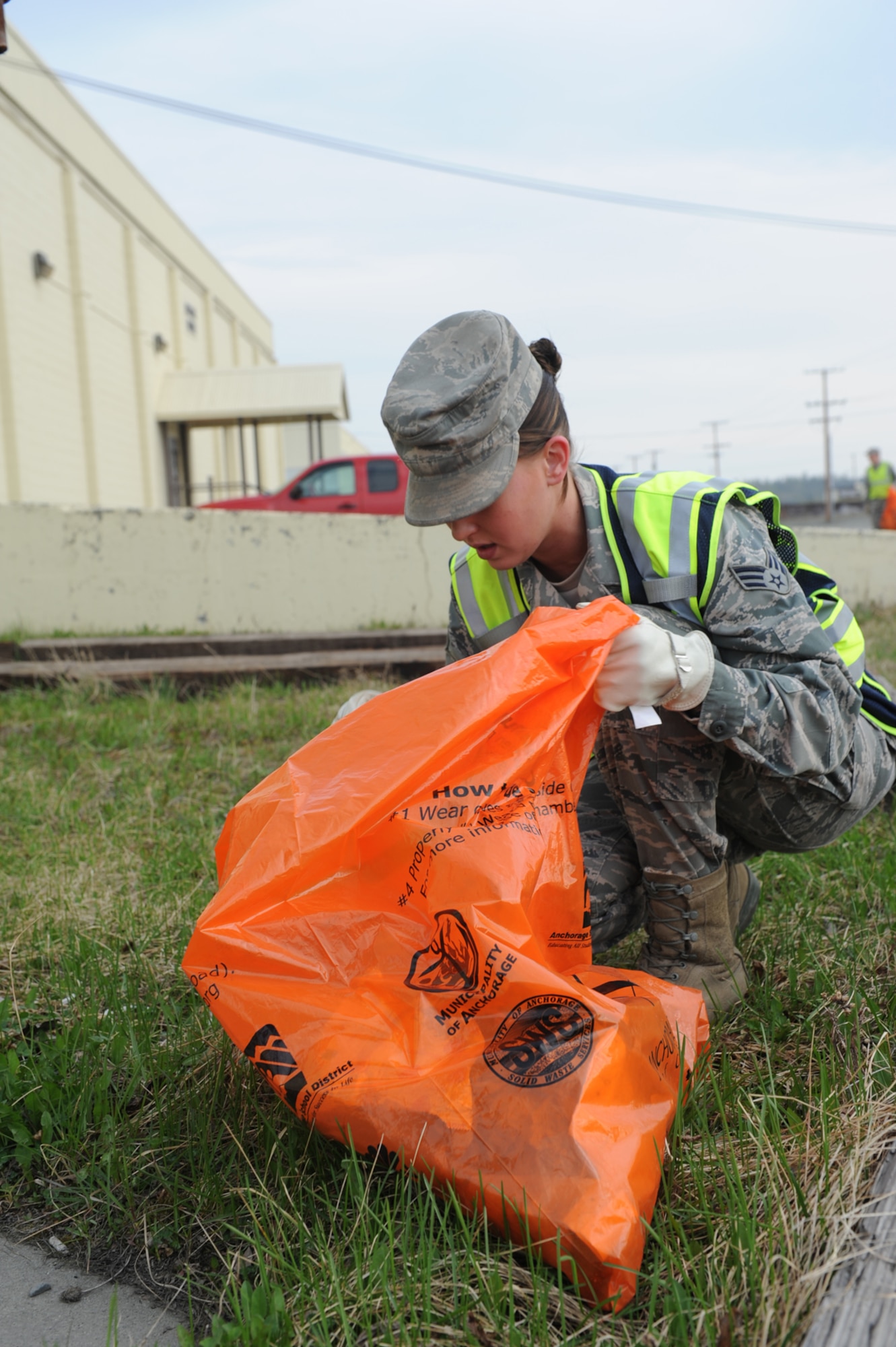 Senior Airman Breana Quimby, 773d Civil Engineer Squadron emergency manager, picks up trash on Joint Base Elmendorf-Richardson, Alaska, May 5, 2014. Airmen and Soldiers across JBER cleaned the installation in support of Operation Clean Sweep. (U.S. Air Force photo/Senior Airman Omari Bernard)