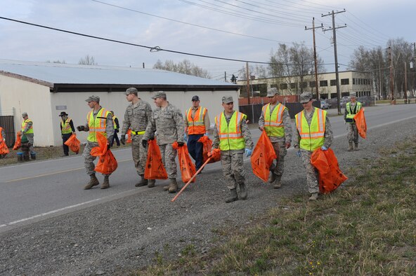 Airmen with the 773d Civil Engineer Squadron scan for trash and debris as they walk down a road on Joint Base Elmendorf-Richardson, Alaska, May 5, 2014. JBER conducted Operation Clean Sweep in support of the Anchorage Chamber of Commerce's 46th Annual Citywide Cleanup Campaign. (U.S. Air Force photo/Senior Airman Omari Bernard)