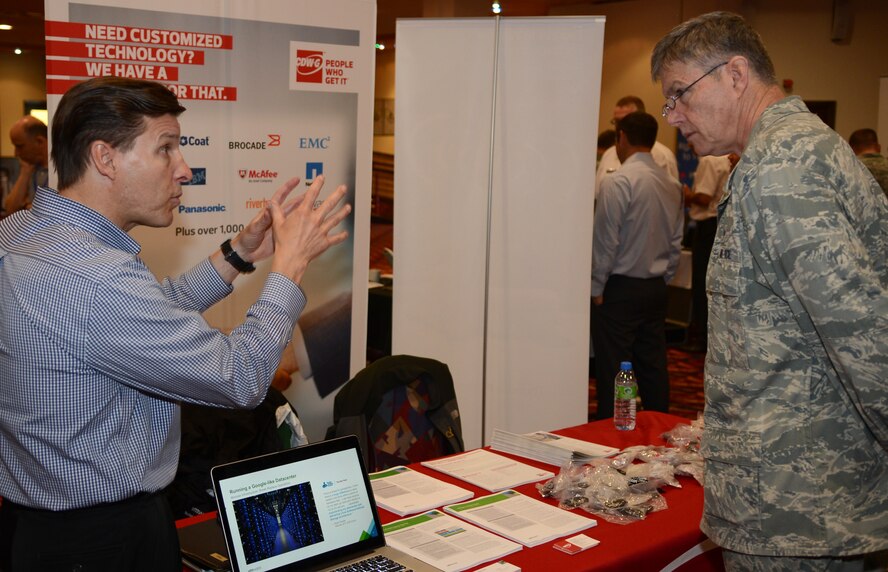 U.S. Air Force Chaplain (Lt. Col.) Henry Close, right, 100th Air Refueling Wing chaplain, listens to a display presenter May 15, 2014, during a technology expo on RAF Mildenhall, England. Vendors showcased various technologies, ranging from cameras to global positioning systems, at the exposition. (U.S. Air Force photo by Airman 1st Class Dillon Johnston/Released)