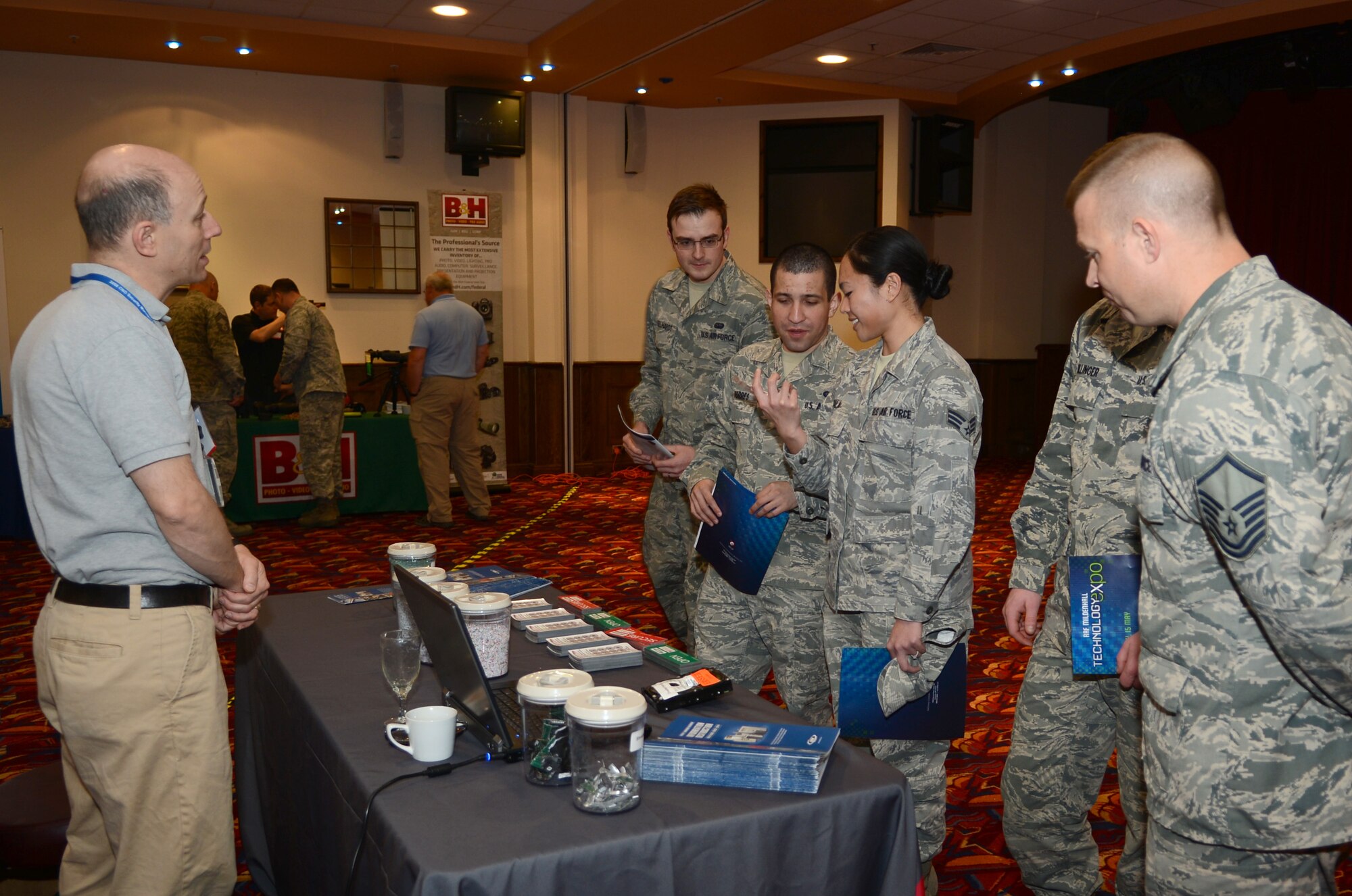 Team Mildenhall members speak with a vendor May 15, 2014, during a technology expo on RAF Mildenhall, England. Vendors from around the world gathered to show off their technologies to different agencies on base. (U.S. Air Force photo by Airman 1st Class Dillon Johnston/Released)