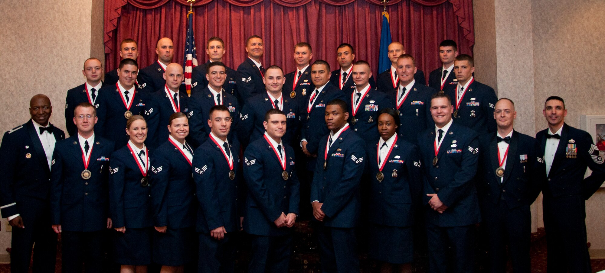 Graduating members of the F.E. Warren Air Force Base, Wyo., Airman Leadership School Class 14-E pose with Col. Carl Jones, 90th Missile Wing vice commander, and Chief Master Sgt. Shawn Drinkard, 90th MW command chief, in the Trail’s End Club May 14, 2014, prior to their graduating ceremony that evening. ALS is required for enlisted Airmen to supervise other Airmen. Photos of individual graduates and award winners can be found at https://www.flickr.com/photos/fewarren_afb/sets/72157644685962164/. (U.S. Air Force photo by Airman 1st Class Jason Wiese)