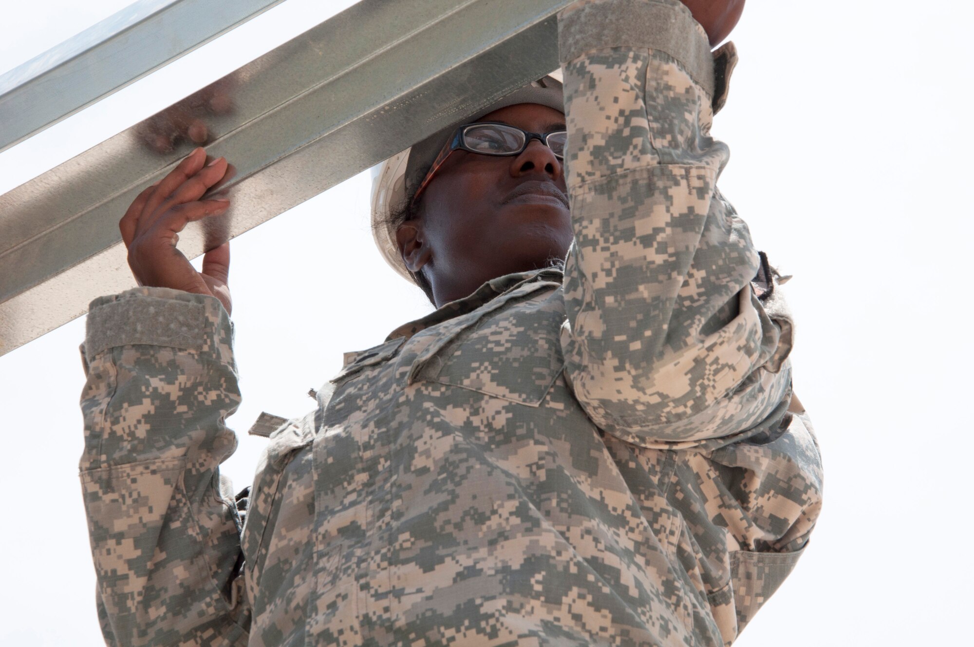 U.S. Army Spc. Jordan Carter, New Horizons electrician from the Louisiana National Guard's 1023rd Vertical Engineer Company, assists with completing the roof on a new preschool building May 13, 2014, at the Hattieville Government School in Hattieville, Belize. BDF and U.S. service members are working together to build five school buildings and one medical facility in Belize during New Horizons Belize 2014. New Horizons is an annual event coordinated between the U.S. and the host nation to provide mutual training opportunities in the fields of health care and civil engineering. (U.S. Air Force photo by Tech. Sgt. Kali L. Gradishar/Released)