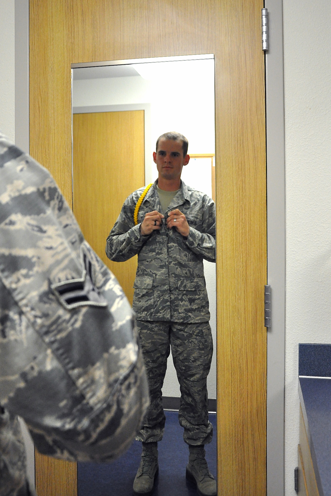GOODFELLOW AIR FORCE BASE, Texas – Airman 1st Class Bradley Jenkins, 312th Training Squadron student and Airmen leader, checks his dress and appearance in his dorm room here April 23. As a yellow rope, Jenkins has to set the standard for other student Airmen to follow. (U.S. Air Force photo/ Airman 1st Class Breonna Veal)
