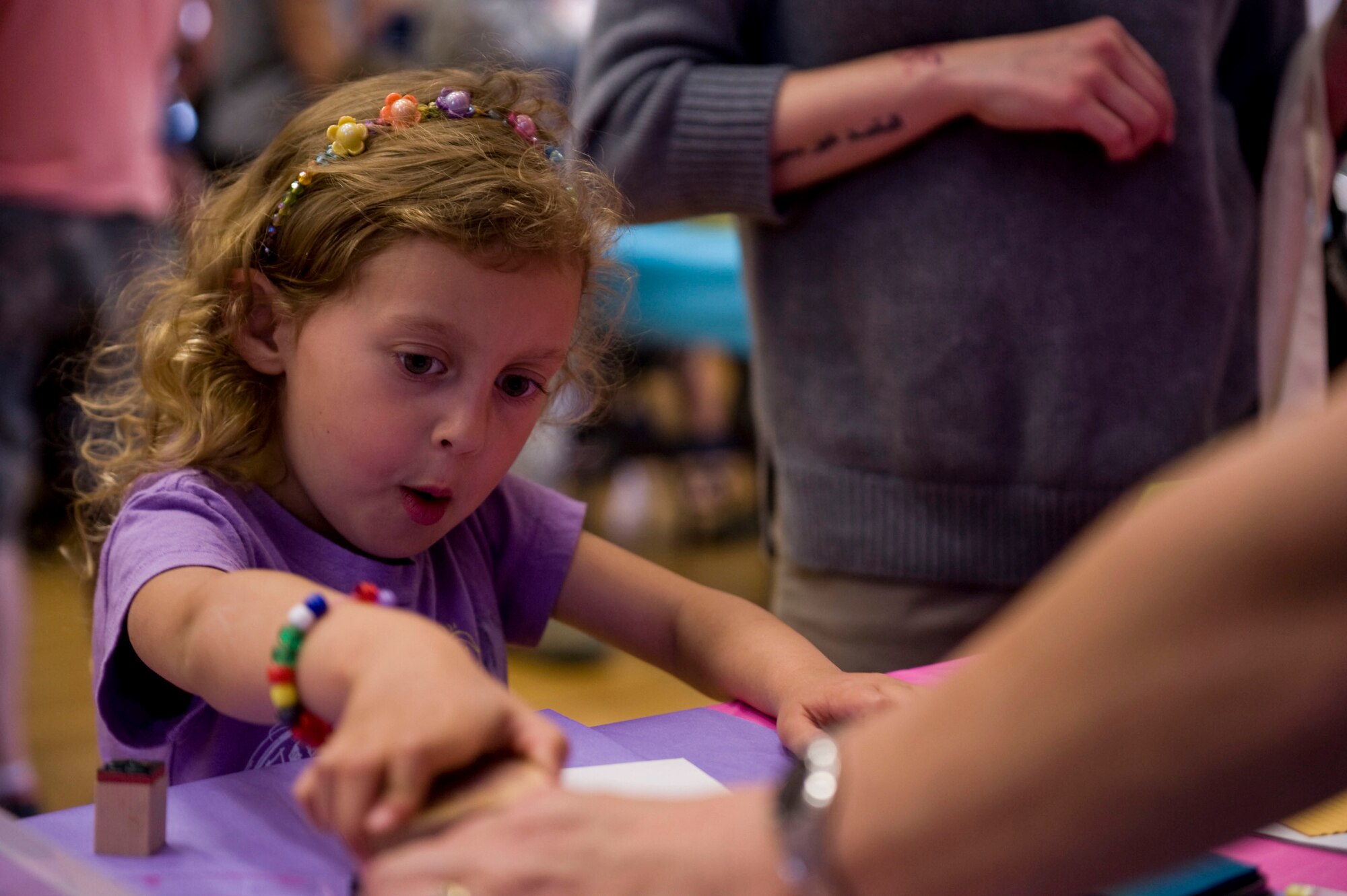 Lauren presses down on a stamp at the 19th Force Support Squadron arts and crafts booth during the Spouse Appreciation Day Bazaar May 9, 2014, at Little Rock Air Force Base, Ark. Spouse Appreciation Day was sponsored by the Airman and Family Readiness Center and included a free tour of Jacksonville, a free spa night and a bazaar. (U.S. Air Force photo by Airman 1st Class Cliffton Dolezal)
