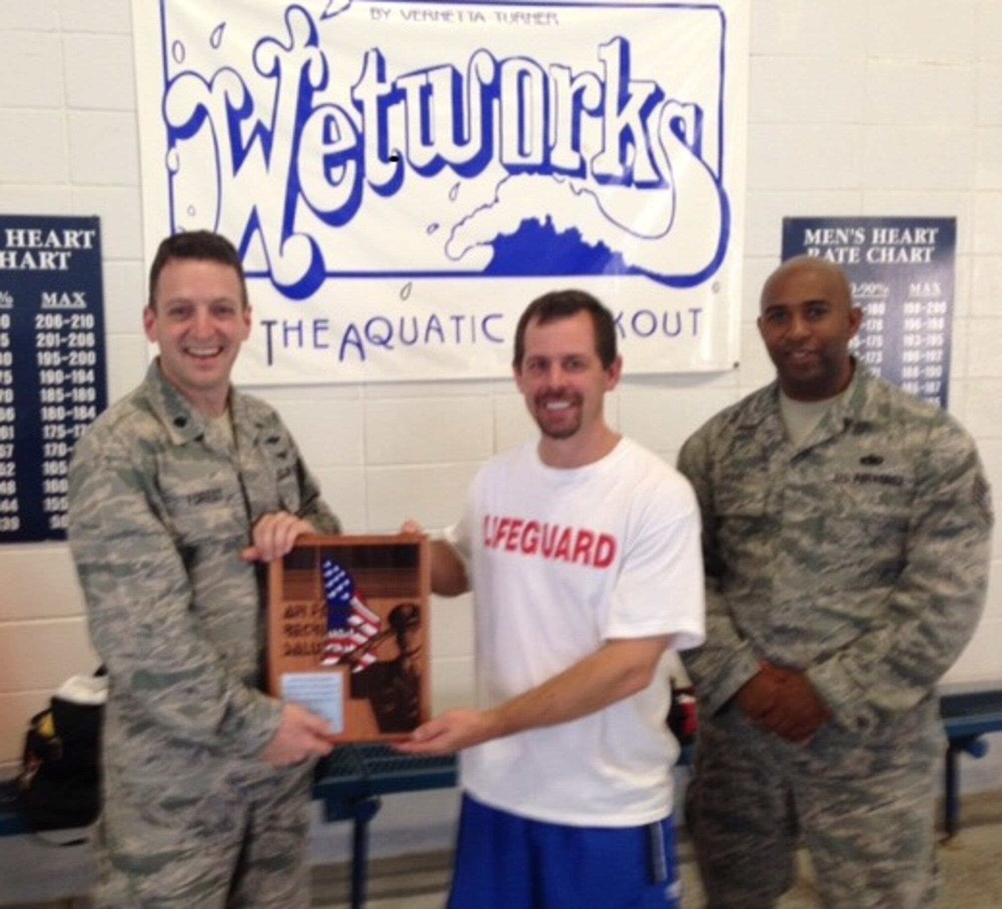 Lt. Col. Benjamin Forest, 344th Recruiting Squadron commander (left), and Tech. Sgt. Jashon Ervin, 344th RCS recruiter, present an Air Force Recruiting Salutes plaque to Jeremy Thomas, Kirby Creek Natatorium aquatic supervisor, for exceptional support toward the Air Force Recruiting Service mission in a ceremony in Dallas, April 18. The Kirby Creek Natatorium has supported AFRS by allowing future Battlefield Airmen the use of their facilities and trainers. (U.S. Air Force photo)

