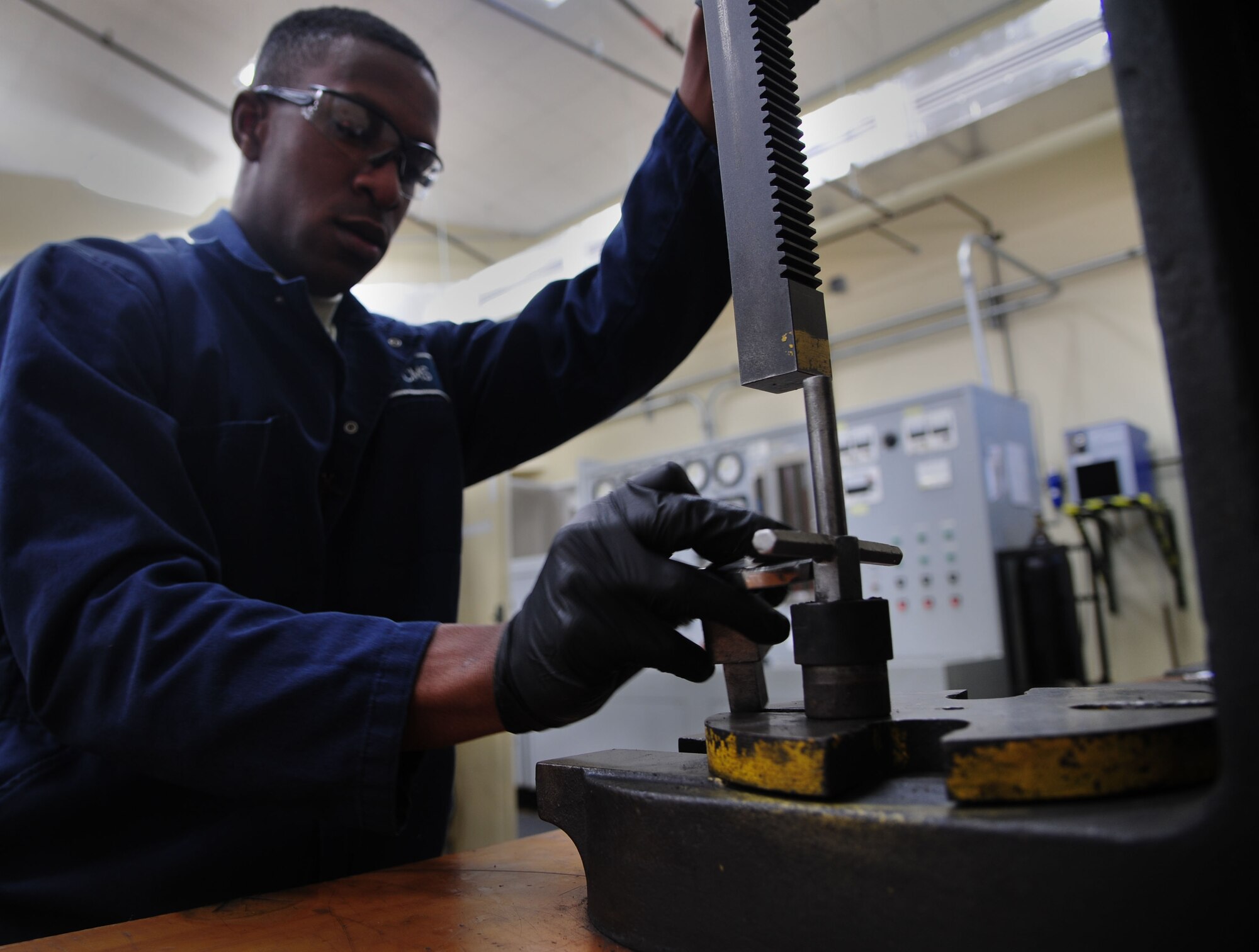 Airman 1st Class Osaro Obayuwana, a 19th Component Maintenance Squadron hydraulics apprentice, builds spring housing for a C-130J brake May 1, 2014, at Little Rock Air Force Base, Ark. The springs are tested to ensure they have the proper strength to push the pressure plates to release the brake. (U.S. Air Force photo by Senior Airman Kaylee Clark)