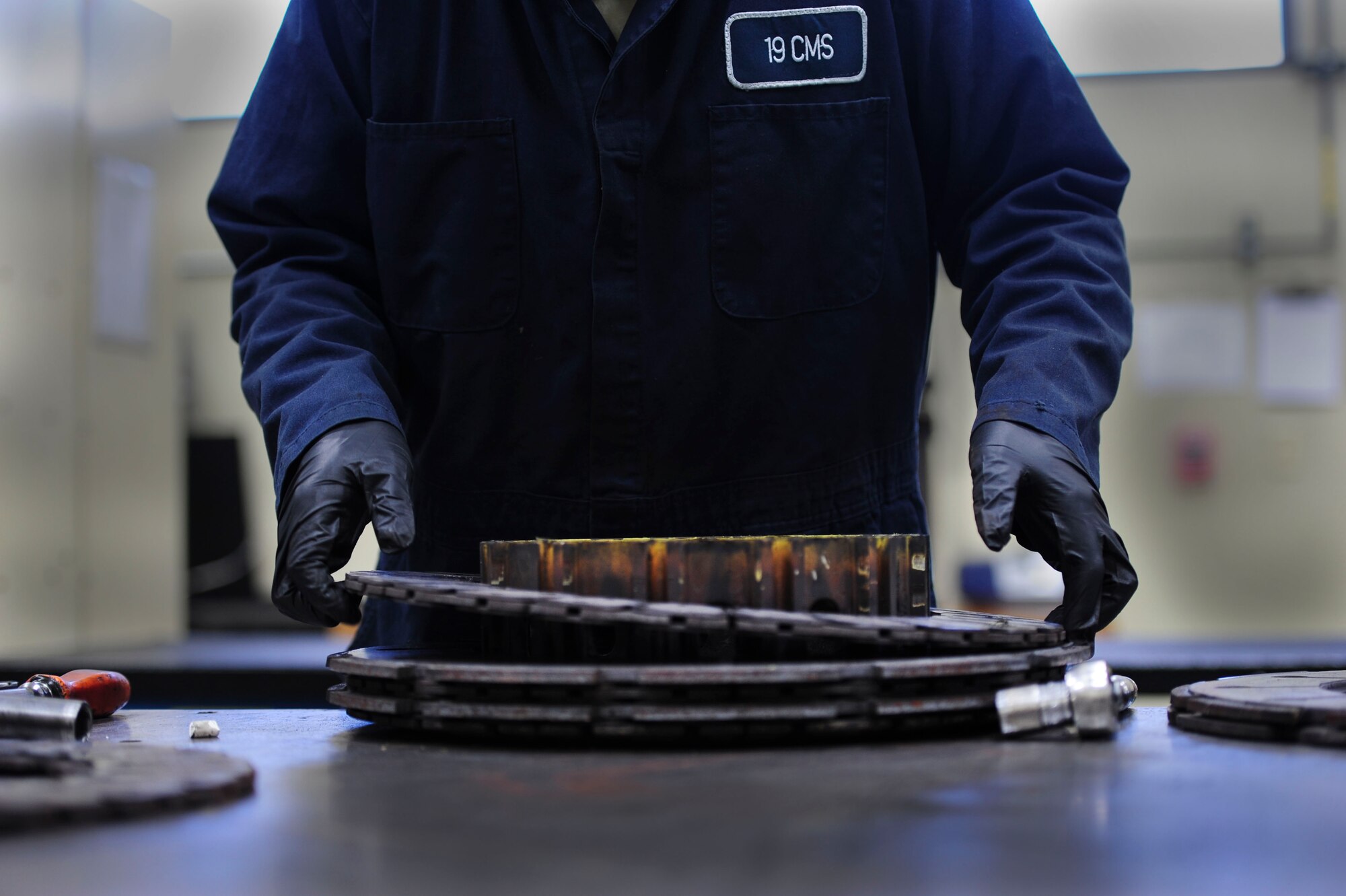 Airman 1st Class Brian Pullen, a 19th Component Maintenance Squadron hydraulics apprentice, removes a C-130J brake pressure plate May 1, 2014, at Little Rock Air Force Base, Ark. Pullen removes the plates and checks them for warping and measures the wear pads for proper thickness. (U.S. Air Force photo by Senior Airman Kaylee Clark)