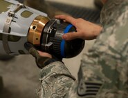 A component is added to the tip of a dummy bomb during a training session at Minot Air Force Base, N.D., May 7, 2014. Training such as this is done weekly to ensure that the Airmen are ready for exercises and real world events. (U.S. Air Force photo/Senior Airman Andrew Crawford)