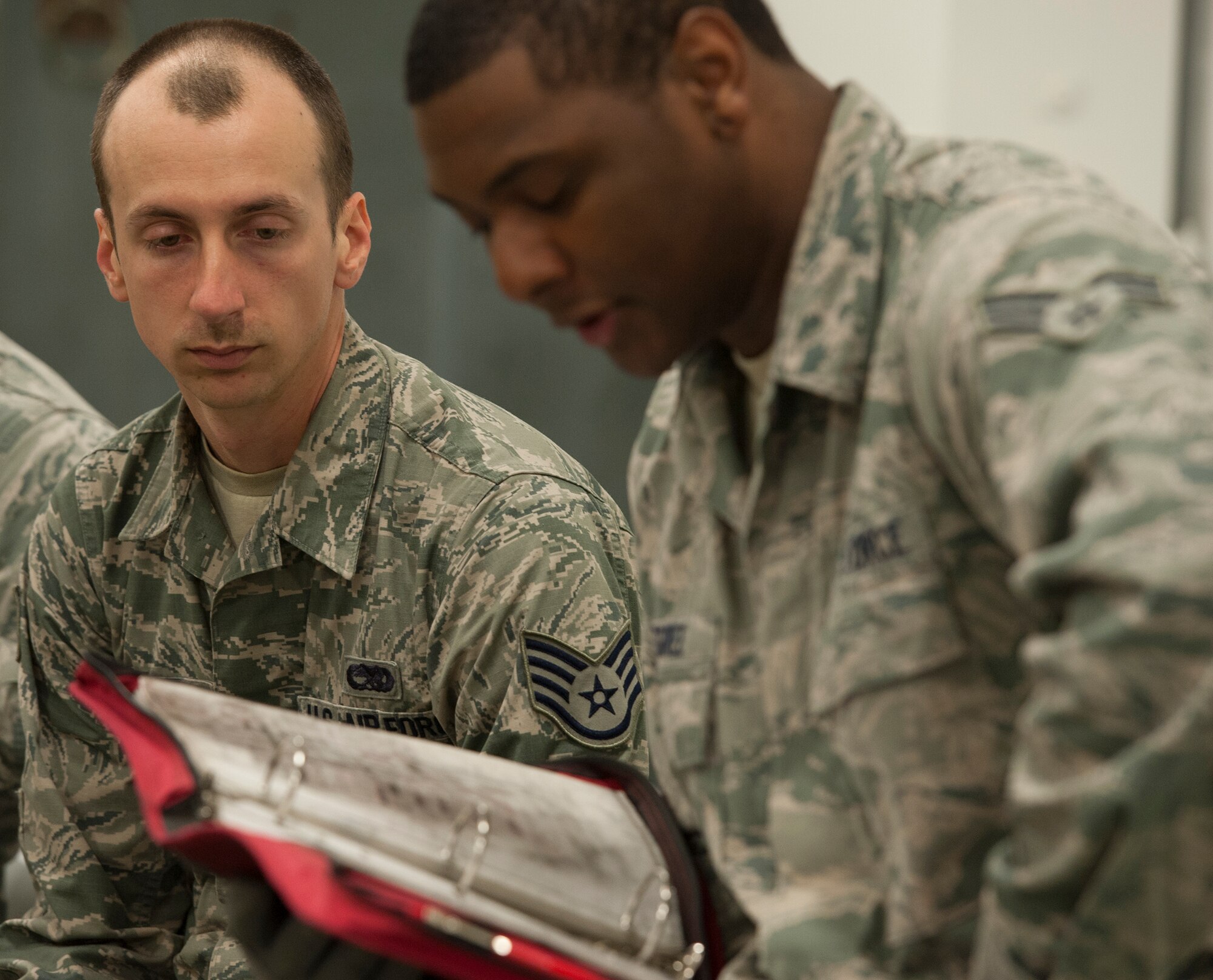 Staff Sgt. Brandon Jones, 5th Munitions Squadron, listens to a safety briefing just before training at Minot Air Force Base, N.D., May 7, 2014. Jones, along with other Airmen in his section, worked to build dummy bombs to prepare for an upcoming exercise. (U.S. Air Force photo/Senior Airman Andrew Crawford)