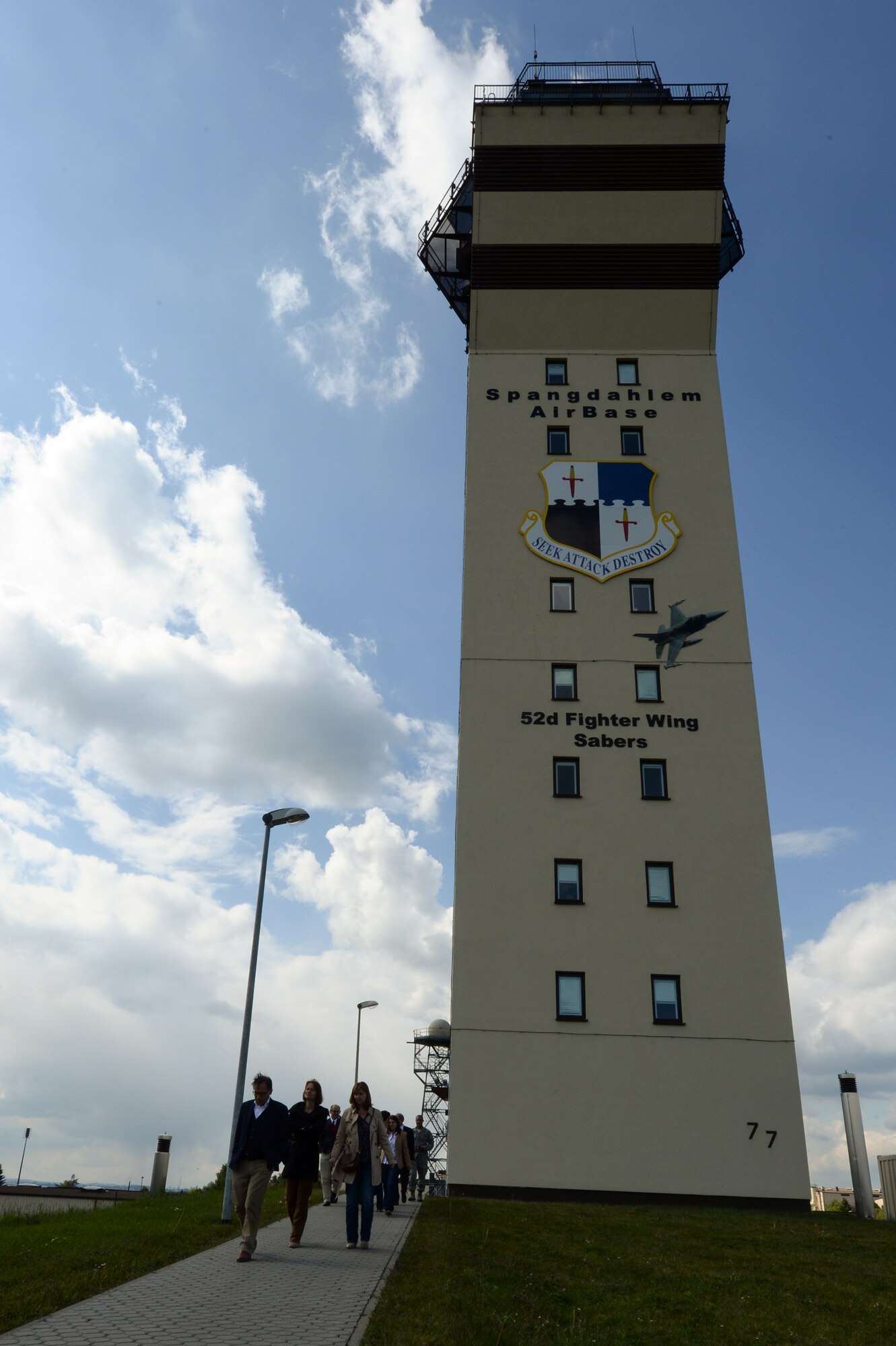 German medical providers walk out of the base tower during a Host Nation Hospital Leader Tour May 14, 2014, at Spangdahlem Air Base, Germany. The tour allowed for members of the local medical community to tour base facilities including the tower, 726th Air Mobility Squadron passenger terminal and the Air Park. (U.S. Air Force photo by Senior Airman Rusty Frank/Released)
