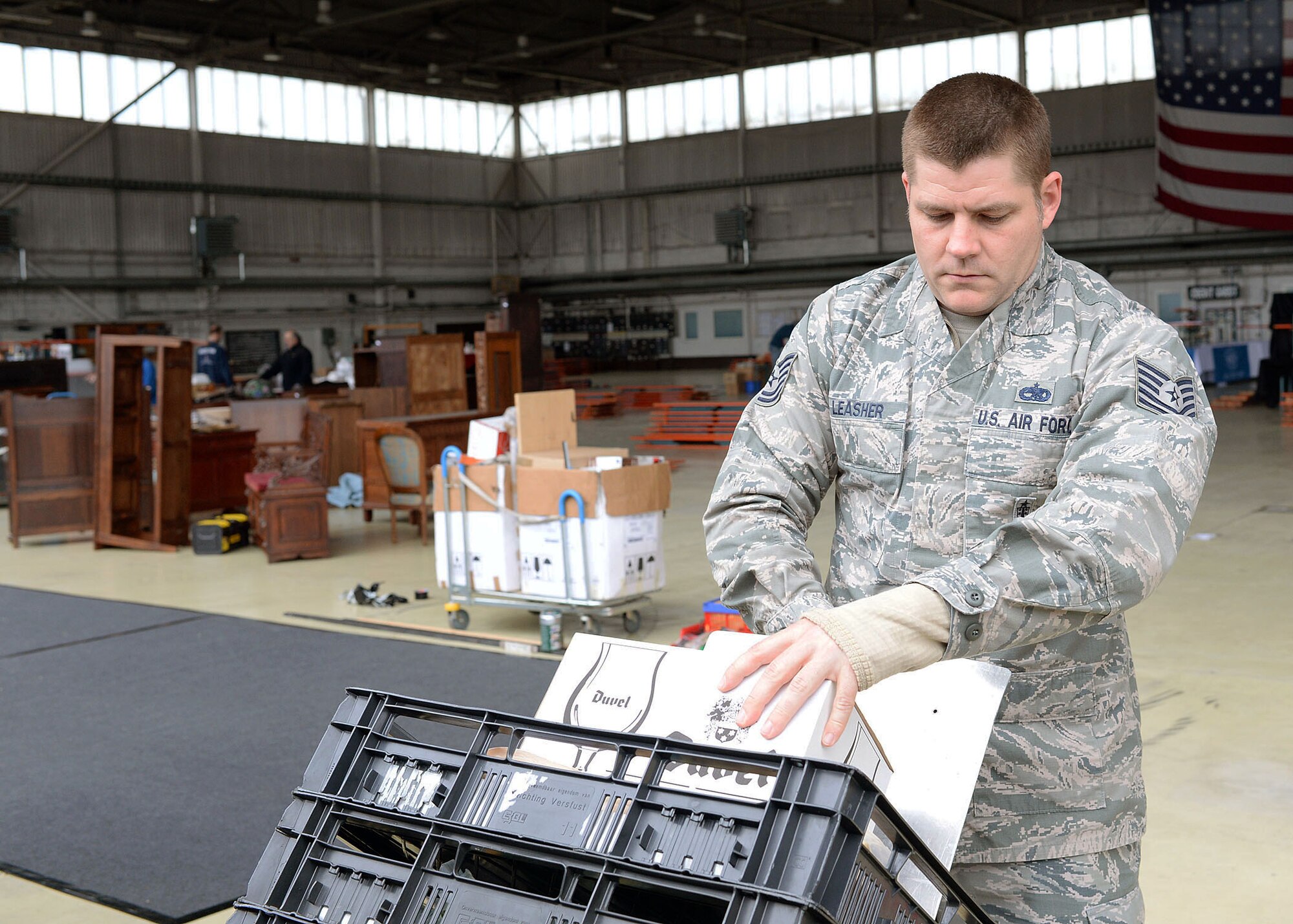 U.S. Air Force Tech. Sgt. Dan Leasher, a Spring Bazaar setup volunteer from Norfolk, Va., wheels a dolly full of cheeses to a nearby booth in Hangar 2 at Spangdahlem Air Base, Germany, May 15, 2014. Base members throughout the 52nd Fighter Wing volunteered their time to help prepare for the weekend opening of the event. (U.S. Air Force photo by Staff Sgt. Daryl Knee/Released)