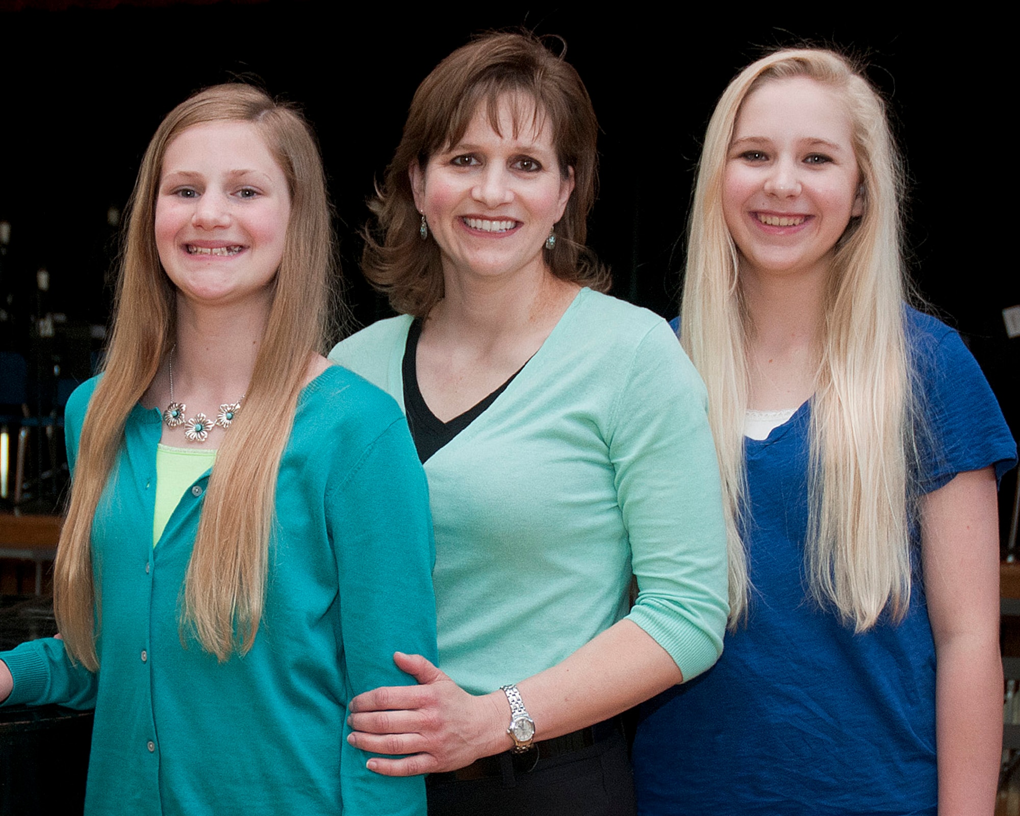 HANSCOM AIR FORCE BASE, Mass. -- Cathy McSwain (center), and her two daughters, Emily (right) and Allison (left), were notified recently that they won the family act of the Air Force Worldwide Family and Teen Talent Contest. The McSwain family performed "Summertime" from "Porgy and Bess" last fall during the local competition that was recorded and forwarded to the Air Force-level "You Got Talent" contest. (U.S. Air Force photo by Mark Wyatt)