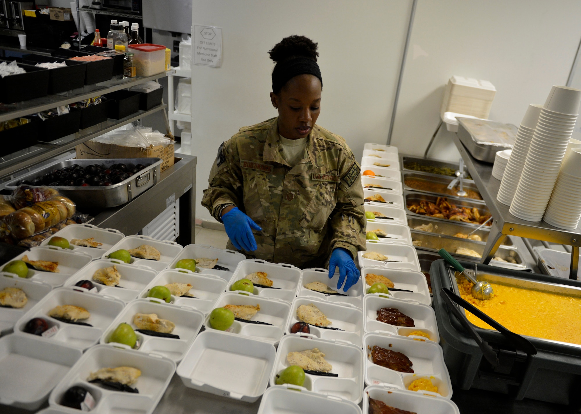 Master Sgt. Janet Budzinack, 455th Expeditionary Medical Support Squadron nutritional medicine flight prepares food trays for patients at Craig Joint Theater Hospital May 13 at Bagram Airfield, Afghanistan.  As part of nutritional medicine, Budzinack provides nutritional care and quality foodservice while promoting military readiness and community wellness. Budzinack is deployed from Wright-Patterson Air Force Base, Ohio and a native of Fontana, Calif. (U.S. Air Force photo by Staff Sgt. Evelyn Chavez/Released)