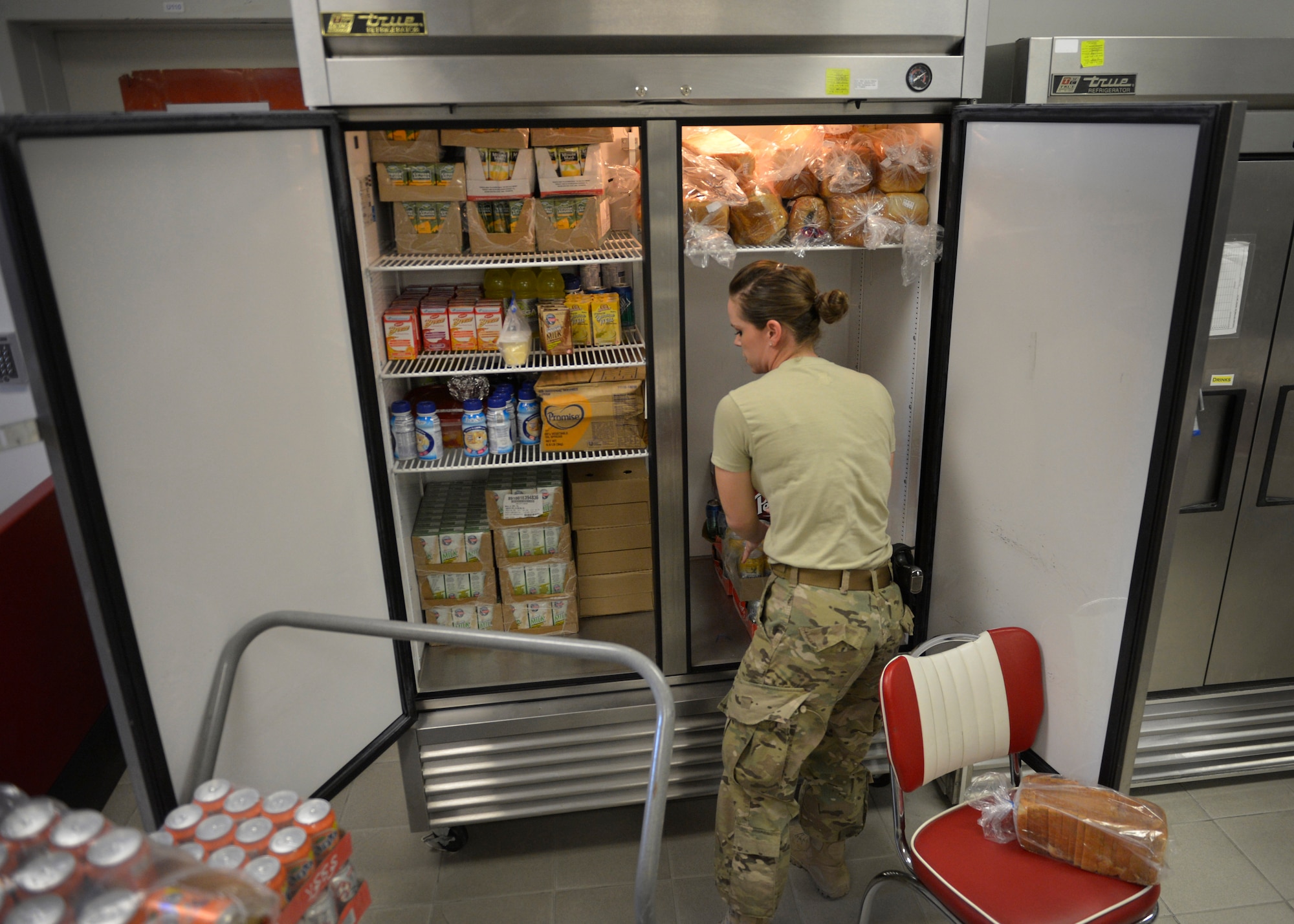 Staff Sgt. Dawn Spence, , 455th Expeditionary Medical Support Squadron nutritional medicine diet technician stocks drinks in a refrigerator  May 13 at Bagram Airfield, Afghanistan.  As part of nutritional medicine, Spence provides nutritional care and quality foodservice while promoting military readiness and community wellness.  Spence is deployed from Lackland Air Force Base, Texas and a native of Paradise, Calif. (U.S. Air Force photo by Staff Sgt. Evelyn Chavez/Released)