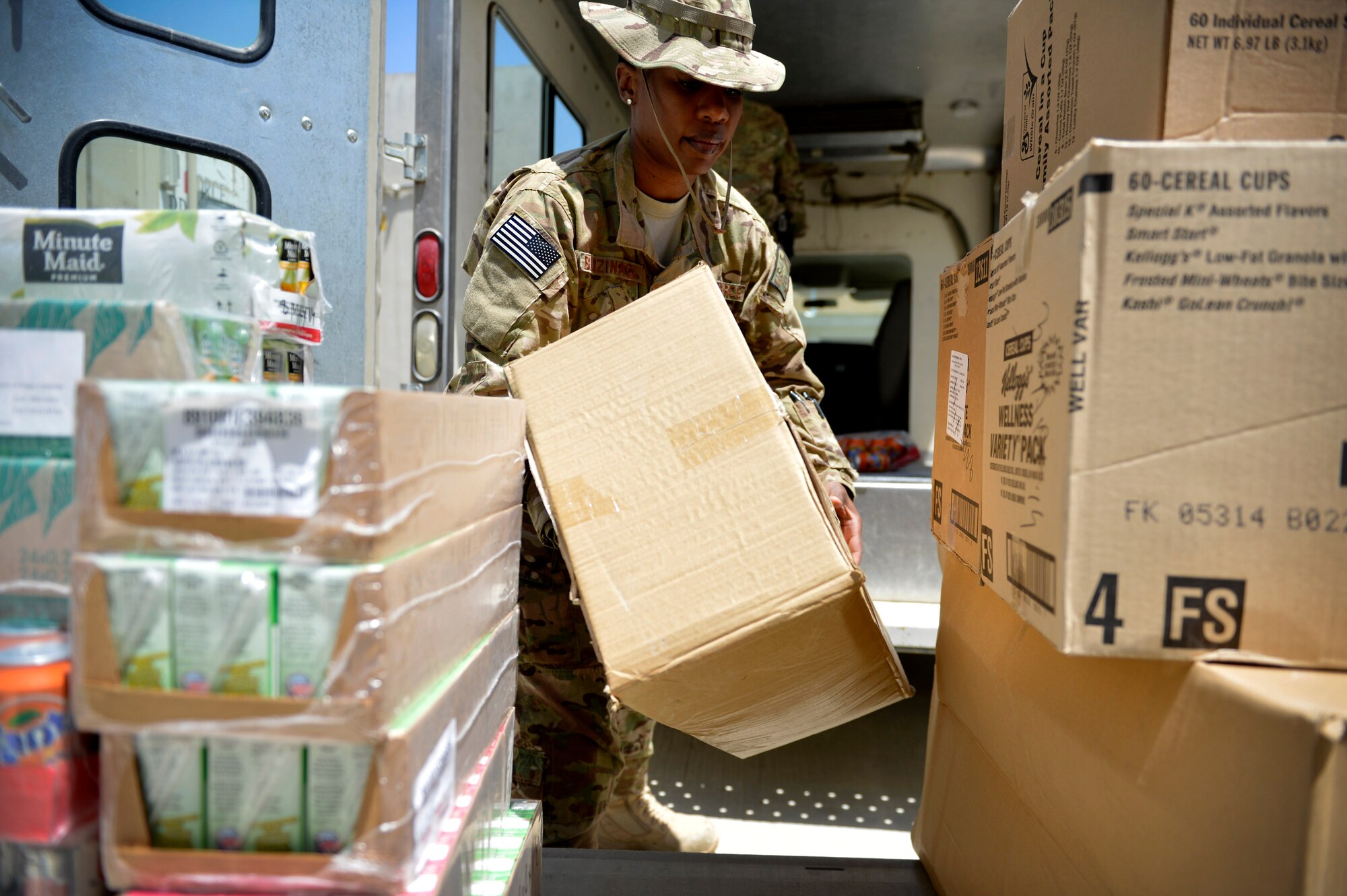 Master Sgt. Janet Budzinack, 455th Expeditionary Medical Support Squadron nutritional medicine flight chief stacks cereal boxes after picking up meals from a dining facility May 13 at Bagram Airfield, Afghanistan.  As part of nutritional medicine, Budzinack provides nutritional care and quality foodservice while promoting military readiness and community wellness. Budzinack is deployed from Wright-Patterson Air Force Base, Ohio and a native of Fontana, Calif. (U.S. Air Force photo by Staff Sgt. Evelyn Chavez/Released)