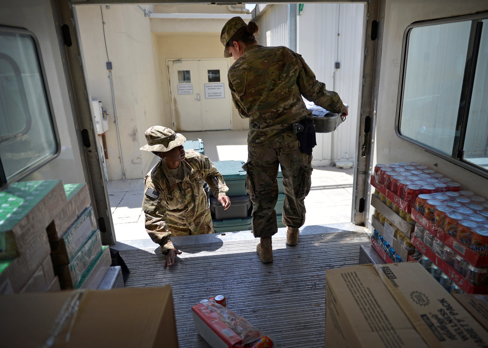 (From left) Master Sgt. Janet Budzinack, 455th Expeditionary Medical Support Squadron nutritional medicine flight chief and Staff Sgt. Dawn Spence, , 455th EMSS nutritional medicine diet technician unload meals off a truck for patients at Craig Joint Theater Hospital May 13 at Bagram Airfield, Afghanistan.  As part of nutritional medicine, they provide nutritional care and quality foodservice while promoting military readiness and community wellness. Budzinack is deployed from Wright-Patterson Air Force Base, Ohio and a native of Fontana, Calif. Spence is deployed from Lackland Air Force Base, Texas and a native of Paradise, Calif. (U.S. Air Force photo by Staff Sgt. Evelyn Chavez/Released)