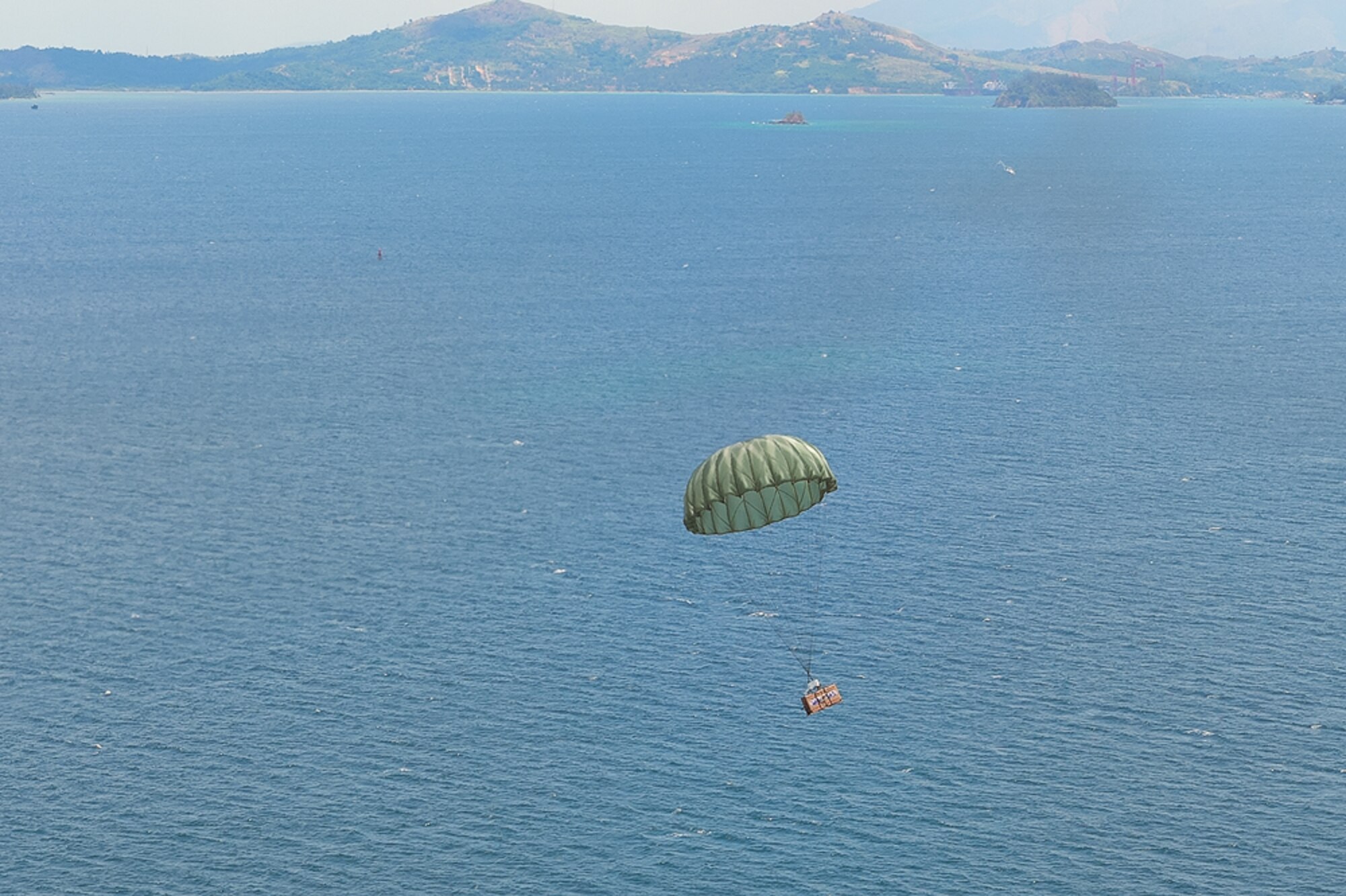 A low-cost, low-altitude (LCLA) bundle exits a C-130H aircraft assigned to the 36th Airlift Squadron, Yokota Air Base, Japan, during Exercise Balikatan near Subic Bay, Republic of the Philippines May 14, 2014. Aircrews from the 36th AS demonstrated the unique LCLA airdrop technique alongside Republic of the Philippine counterparts in order to practice the ability to deliver humanitarian aid and supplies to remote regions. (Courtesy photo by U.S. Air Force Maj. Teodoro Apalisok)