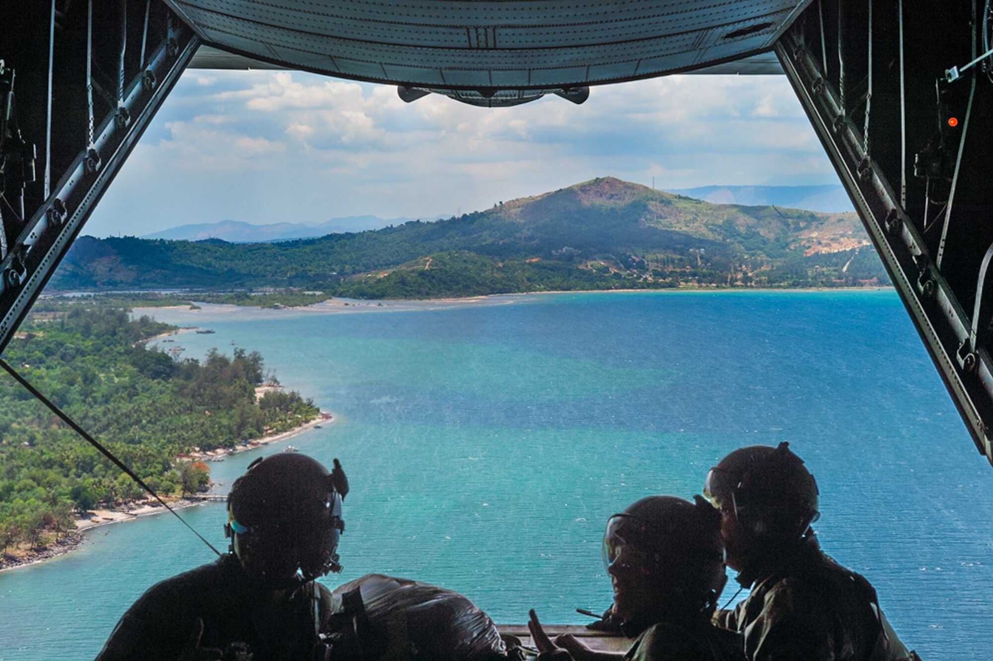 A loadmaster assigned to the 36th Airlift Squadron, Yokota Air Base, Japan, and Philippine Navy personnel prepare to deploy a low-cost, low-altitude (LCLA) bundle from a U.S. Air Force C-130H aircraft during Exercise Balikatan near Subic Bay, Republic of the Philippines May 14, 2014. Aircrews from the 36th AS demonstrated the unique LCLA airdrop technique alongside Republic of the Philippine counterparts in order to practice the ability to deliver humanitarian aid and supplies to remote regions. (Courtesy photo by U.S. Air Force Maj. Teodoro Apalisok)