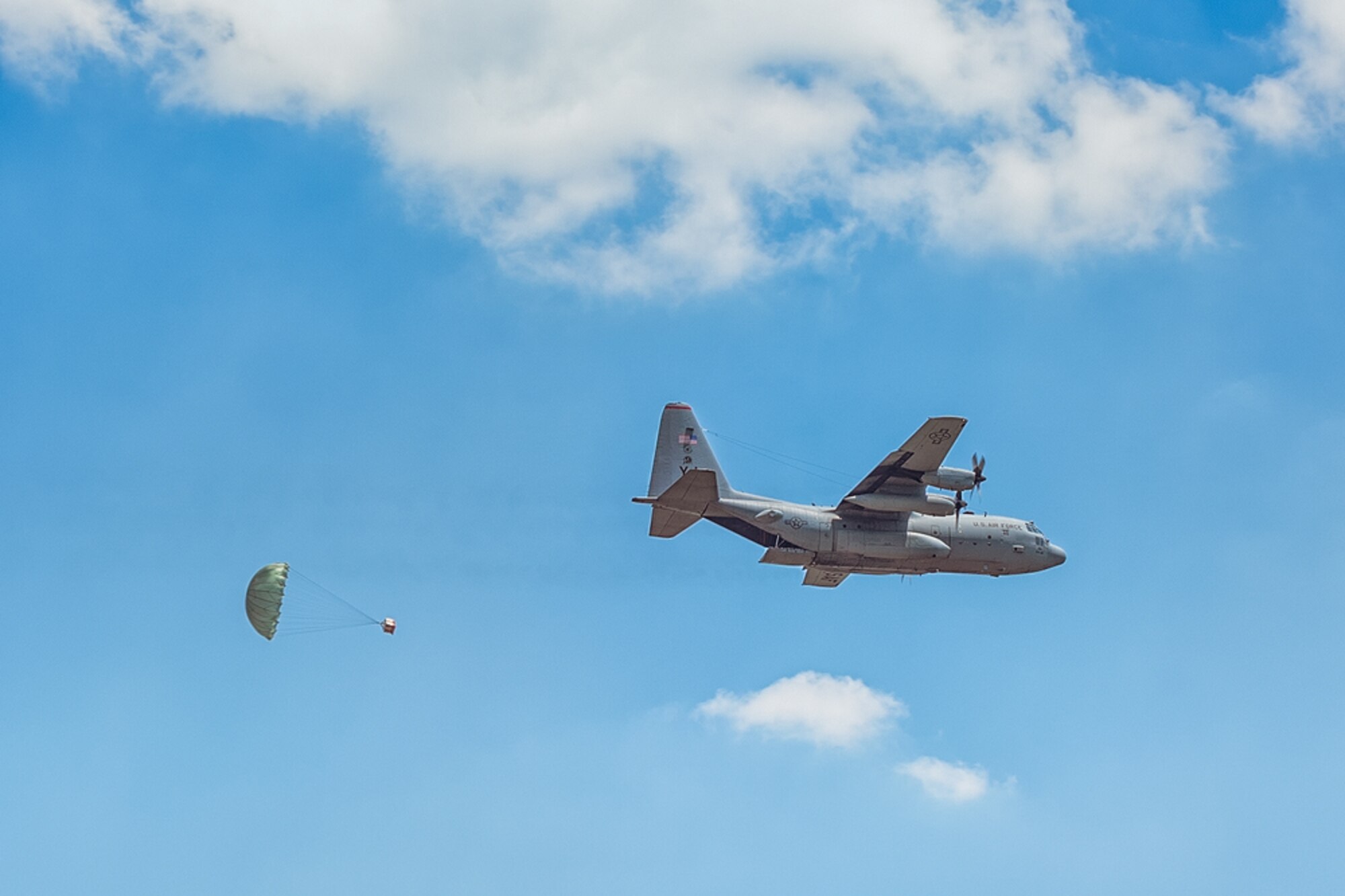 A C-130H aircraft assigned to the 36th Airlift Squadron, Yokota Air Base, Japan, delivers a low-cost, low-altitude (LCLA) bundle during Exercise Balikatan near Basa, Republic of the Philippines May 13, 2014. Aircrews from the 36th AS demonstrated the unique LCLA airdrop technique alongside Republic of the Philippine counterparts in order to practice the ability to deliver humanitarian aid and supplies to remote regions. (Courtesy photo by U.S. Air Force Maj. Teodoro Apalisok)