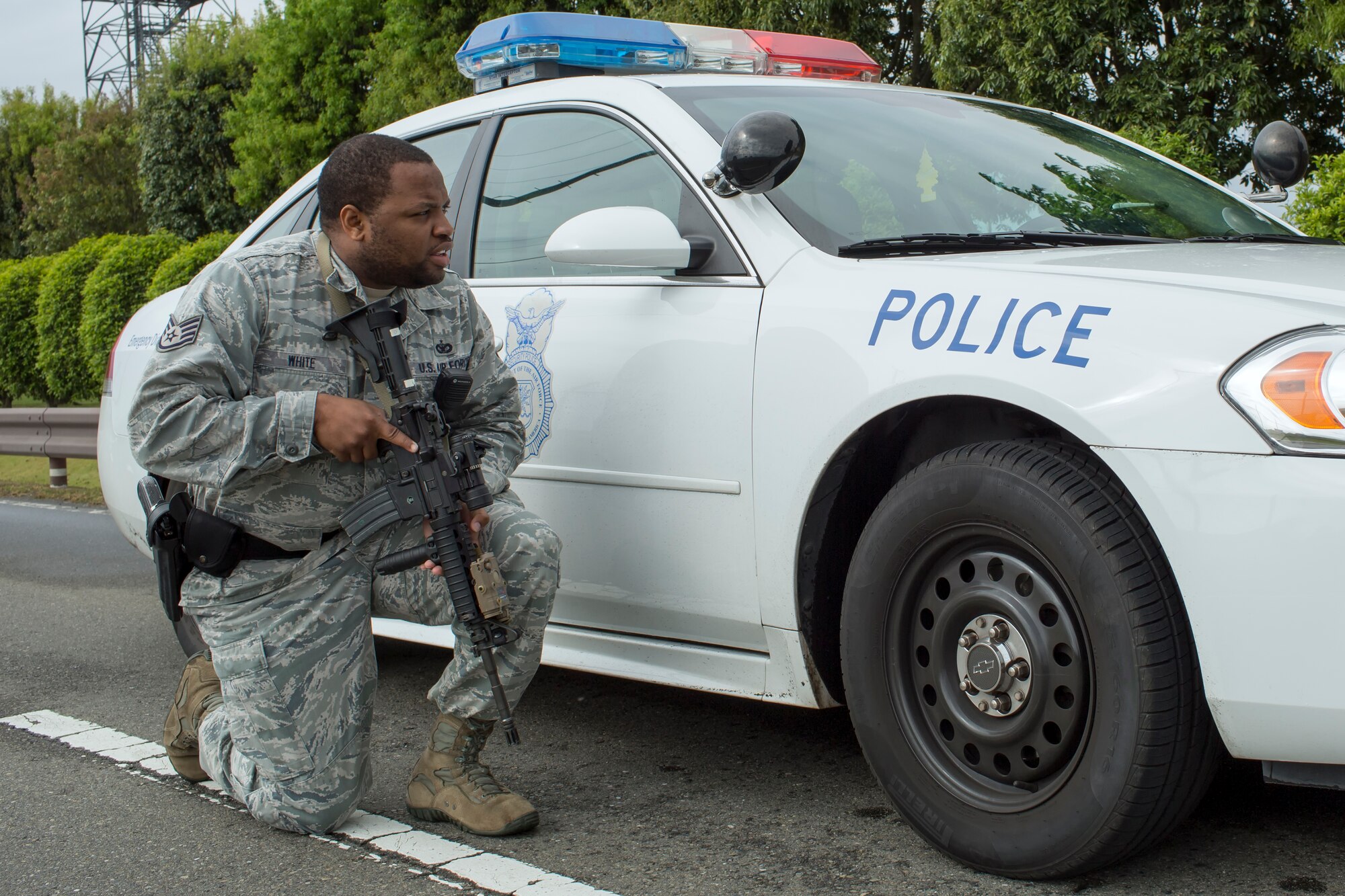Staff Sgt. Terell White, 374th Security Forces Squadron patrolman, arrives on the scene of a simulated active shooter event at Yokota Air Base, Japan, May 15, 2014. The active shooter scenario tested the threat response capability of Yokota’s first responders. (U.S. Air Force photo by Osakabe Yasuo/Released)