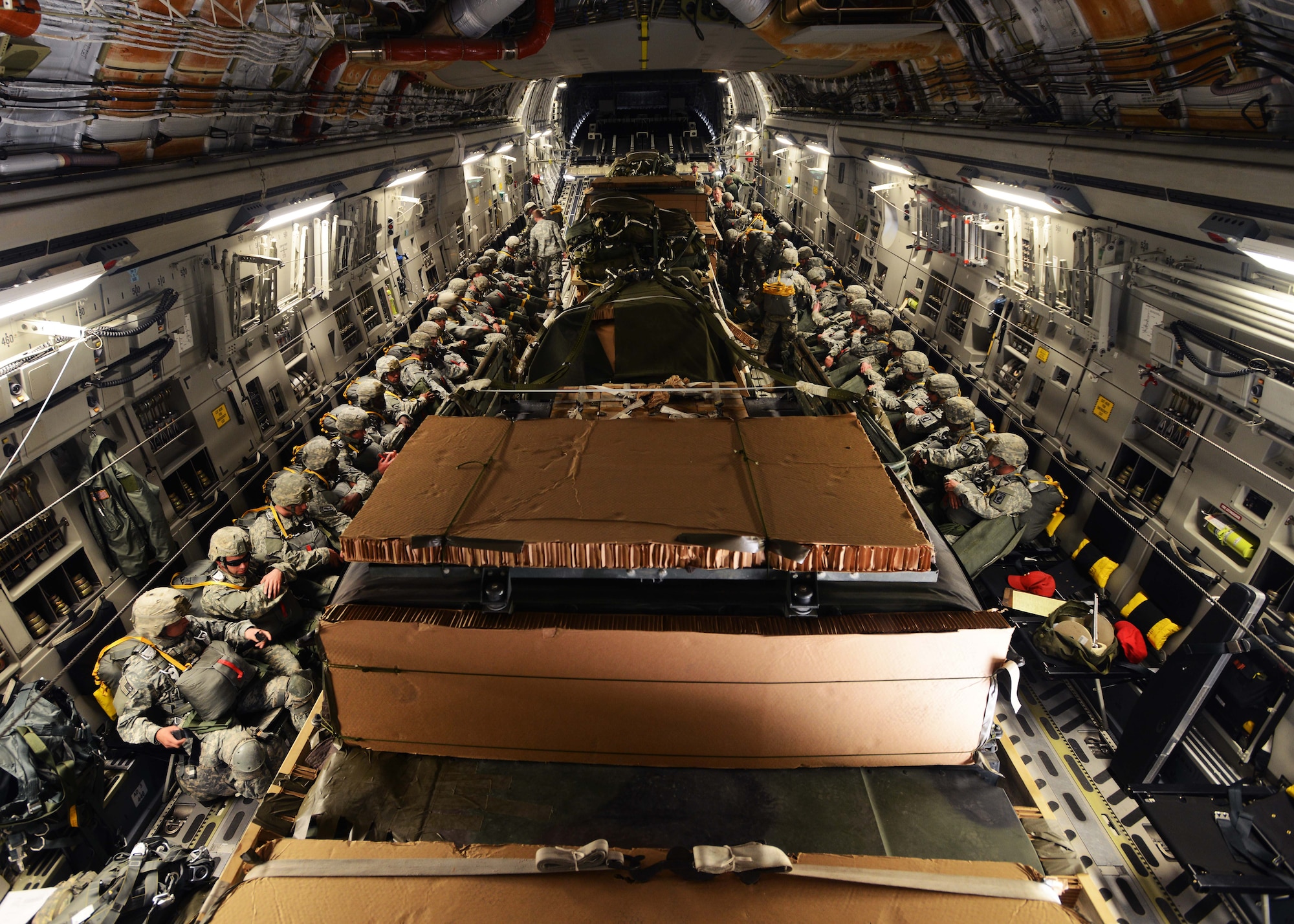 A platoon of approximately 30 airborne field artillery paratroopers from Bravo Battery, 4th Battalion, 319th Airborne Field Artillery Regiment, wait to depart from Aviano Air Base, Italy, May 12, 2014, on a C-17 Globemaster III. The platoon deployed to Poland in support of U.S. Army Europe’s Land Forces Assurance Exercises. (U.S. Air Force photo/Airman 1st Class Deana Heitzman)