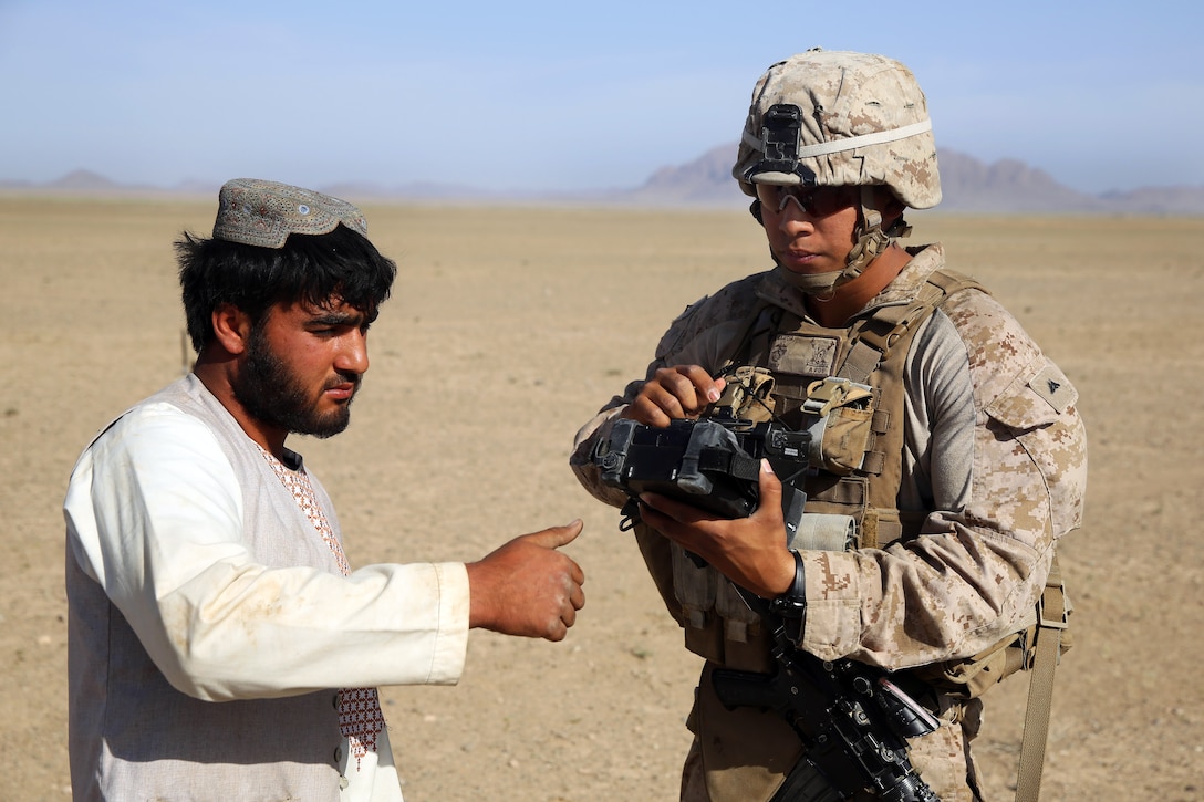 U.S. Marine Corps Lance Cpl. Isaac Garcia utilizes a Biometric Enrollment and Screening Device during a mission in Afghanistan's Helmand province, May 2, 2014. Garcia, an assaultman, is assigned to Weapons Company, 1st Battalion, 7th Marine Regiment.