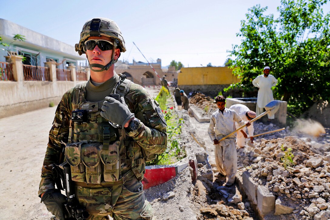 U.S. Army Spc. Matt Cullen checks communications during a meeting with the Farah provincial chief justice in Farah City, Afghanistan, May 4, 2013. Cullen is assigned to the Provincial Reconstruction Team Farah's security force.  
