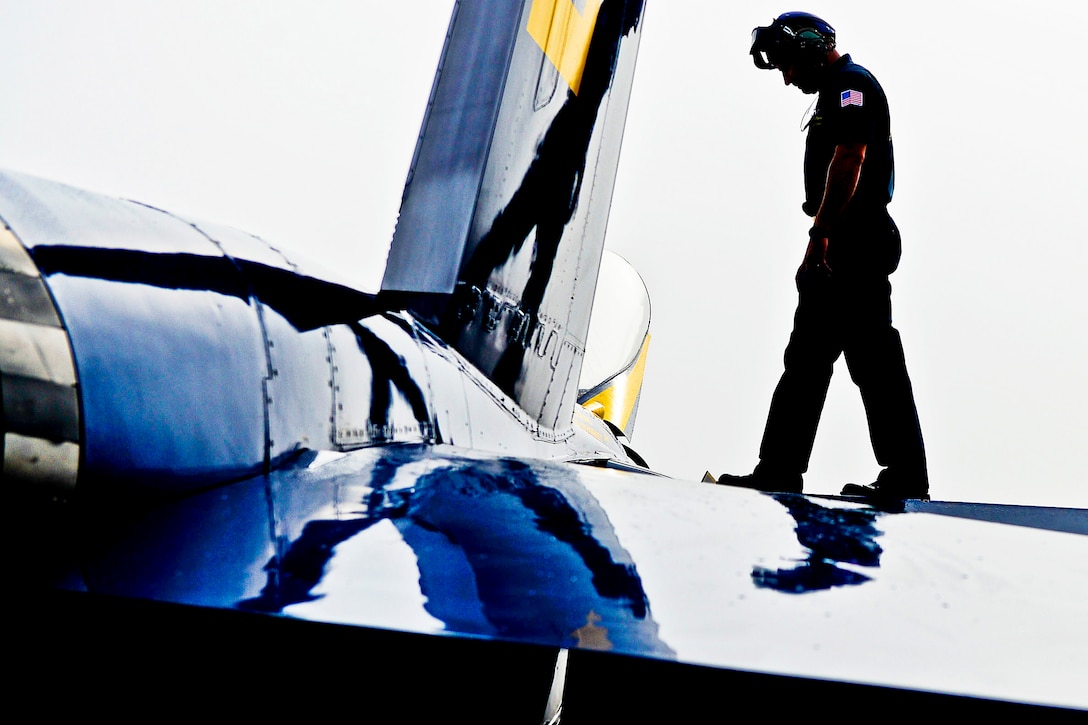 Navy Petty Officer 1st Class Benjamin Liskey inspects an F/A-18 Hornet before a flight during morning operations in Pensacola, Fla., May 8, 2013. Liskey is assigned to the Blue Angels, the Navy's flight demonstration squadron.  
