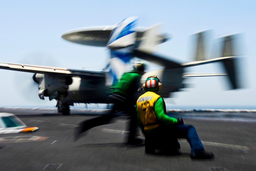 U.S. sailors move into position after an E-2C Hawkeye launches from the flight deck of the aircraft carrier USS Dwight D. Eisenhower in the North Arabian Sea, May 7, 2013. The Eisenhower is deployed to the U.S. 5th Fleet area of responsibility to conduct maritime security operations, theater security cooperation efforts and support missions as part of Operation Enduring Freedom. The sailors are assigned to Carrier Airborne Early Warning Squadron 121.  
