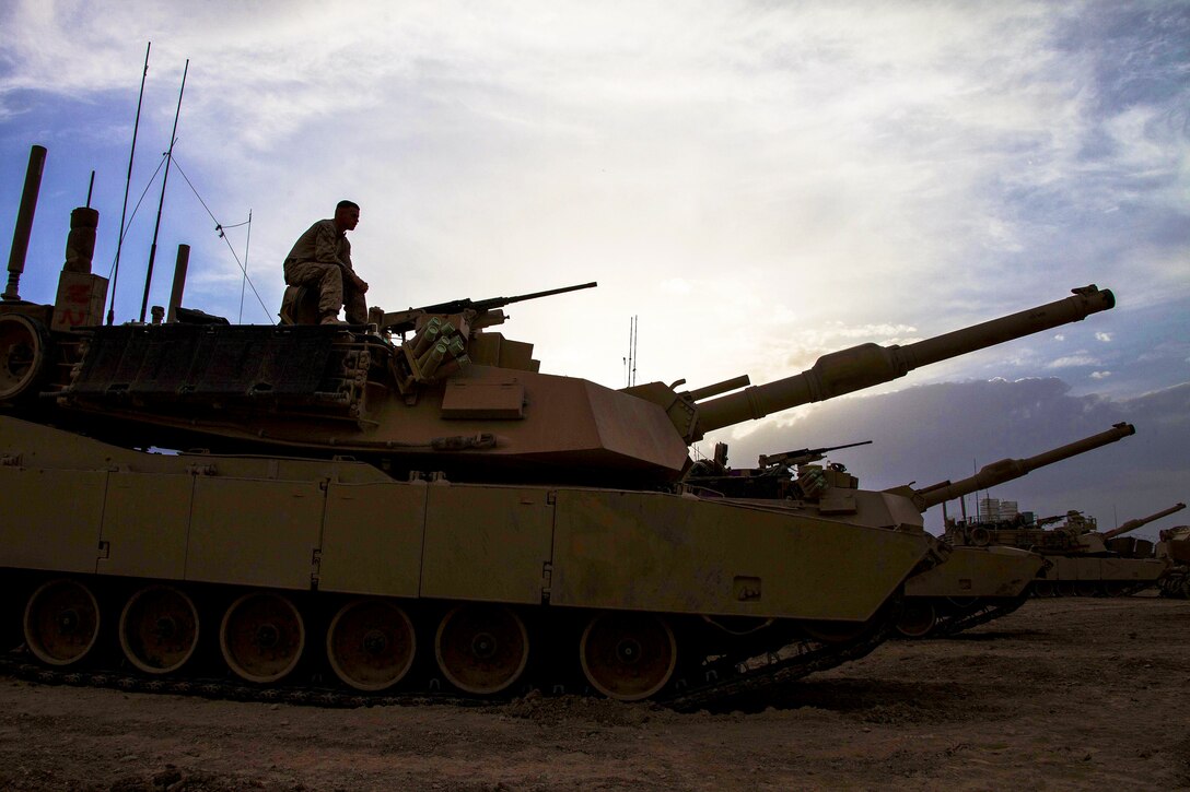 U.S. Marine Corps Cpl. Joseph Ordille takes a pause from conducting function checks on an M1A1 Abrams tank on Camp Shir Ghazay in Afghanistan's Helmand province, April 25, 2013.  
