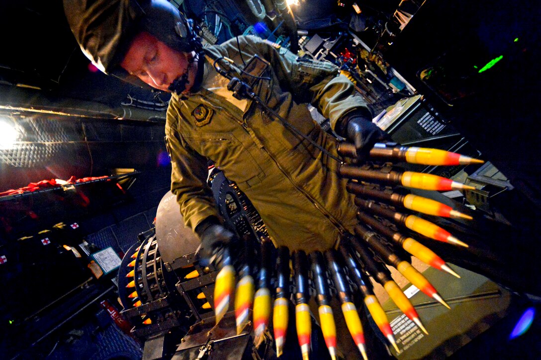 An Air Force AC-130W Scorpion II aerial gunner reloads 30mm ammunition in a flight during Emerald Warrior 2013 on Hurlburt Field, Fla., April 24, 2013. The annual tactical exercise is designed to leverage lessons learned from operations Iraqi and Enduring Freedom to provide trained and ready forces to combatant commanders. U.S. Air Force photo by Senior Airman Matthew Bruch  
