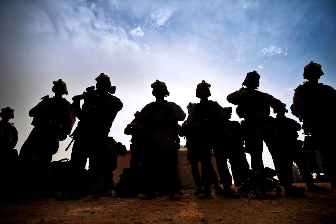 U.S. Marines wait for instruction from their squad leader before participating in Eagle Resolve 2013 on Camp Al-Galail, Qatar, April 21, 2013. 
