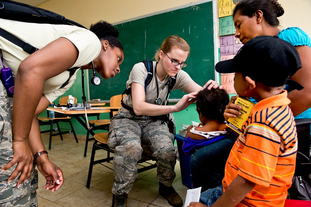U.S. Air Force Capts. Rebecca Slogic, center, and Chauncey Tarrant examine a child during medical readiness training as part of Beyond the Horizon 2013 in Cerro Plata, Panama, April 15, 2013. Slogic and Tarrant are pediatricians assigned to the San Antonio Military Medical Center in Texas.  
