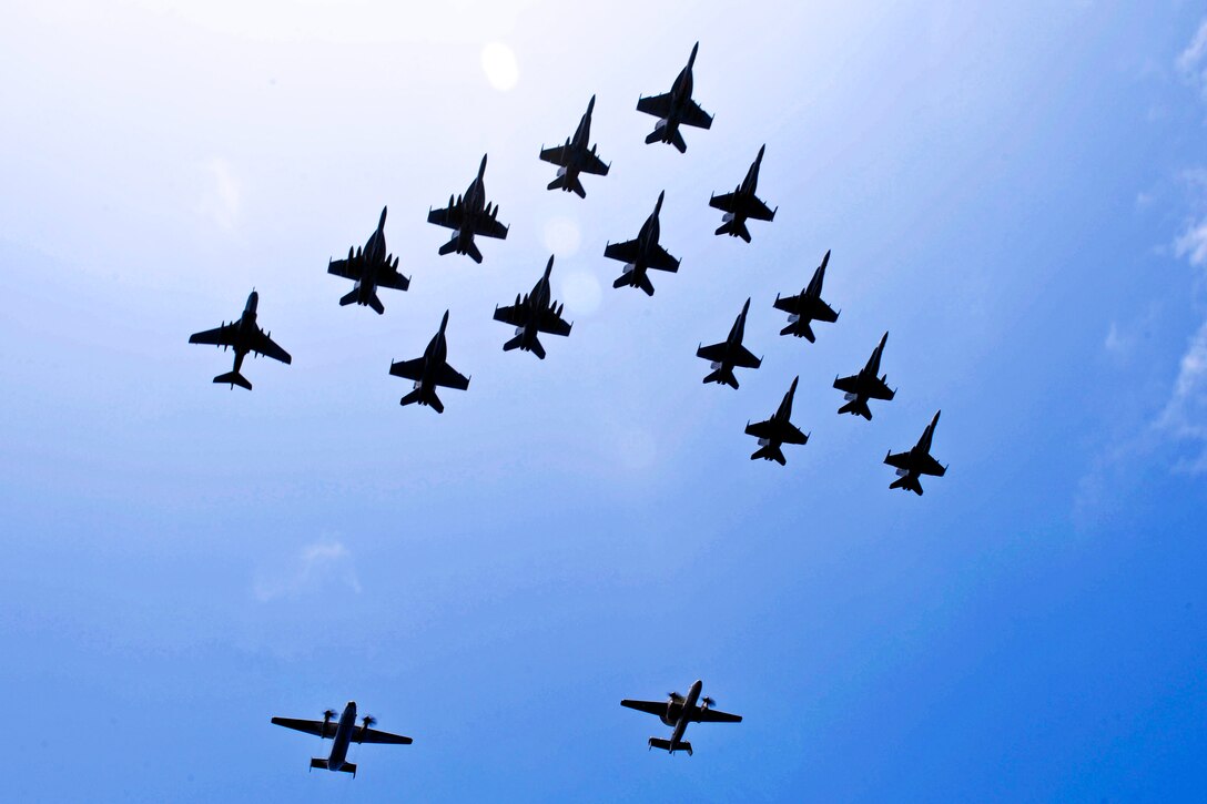 Aircraft fly in formation during a demonstration above the aircraft carrier USS John C. Stennis in the Pacific Ocean, April 20, 2013. The aircraft are assigned to the John C. Stennis Carrier Strike Group, which is returning from an eight-month deployment in areas of responsibility for the U.S. 5th and 7th fleets.  
