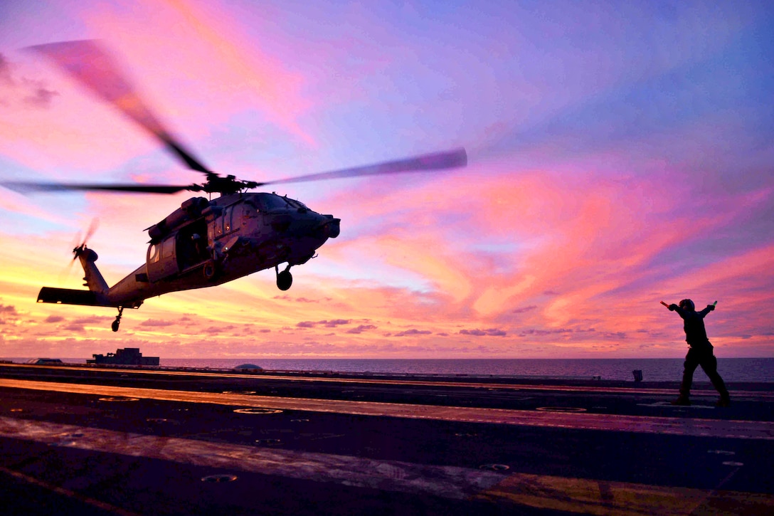 U.S. Navy Seaman Isia Washington directs an MH-60S Sea Hawk helicopter from Helicopter Sea Combat Squadron 8 to land on the flight deck aboard the aircraft carrier USS John C. Stennis underway in the Pacific Ocean, April 10, 2013. Washington is an aviation ordnanceman airman. 
